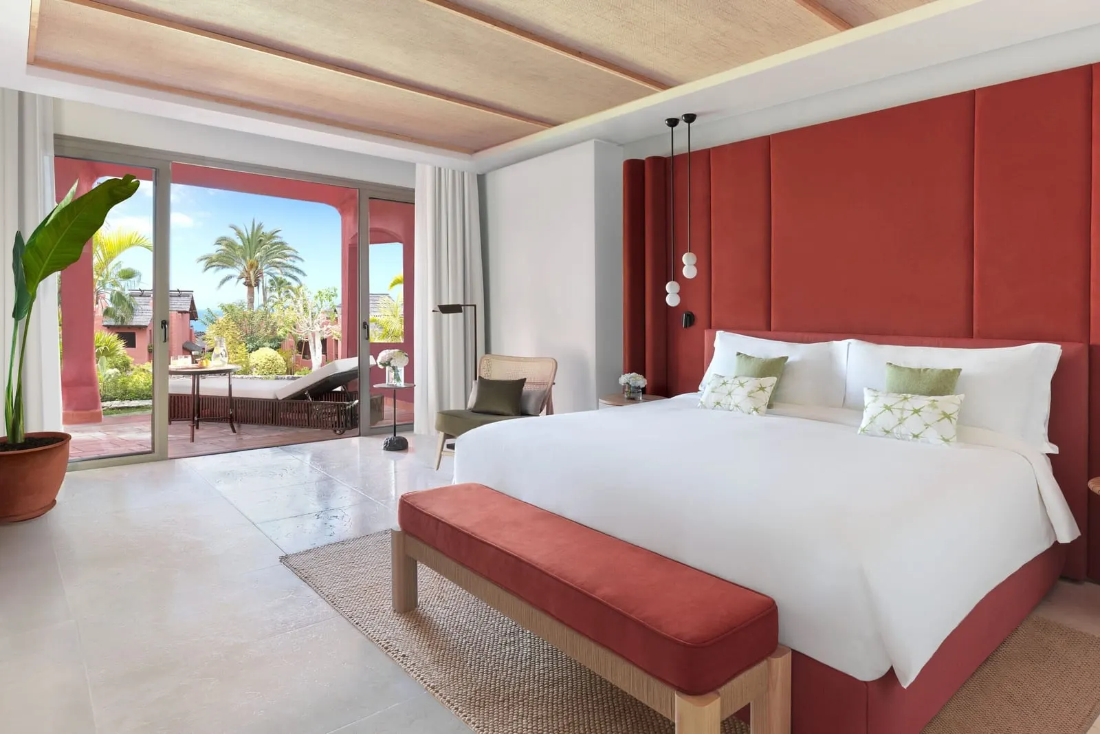 Retreat One Bedroom Suite Garden View at the Ritz-Carlton Abama: the bedroom, a king bed with a red bench and terrace doors