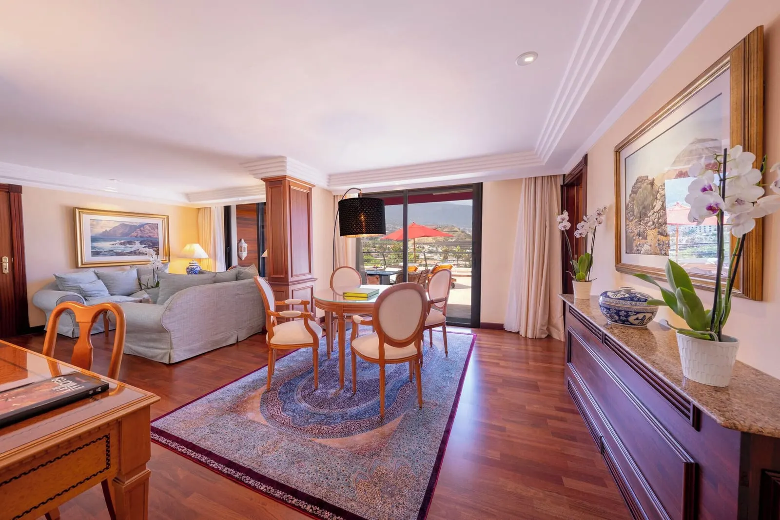 2 Bedroom Penthouse Suite at Hotel Botánico: the living room, a sofa and a dining table by doors to the terrace