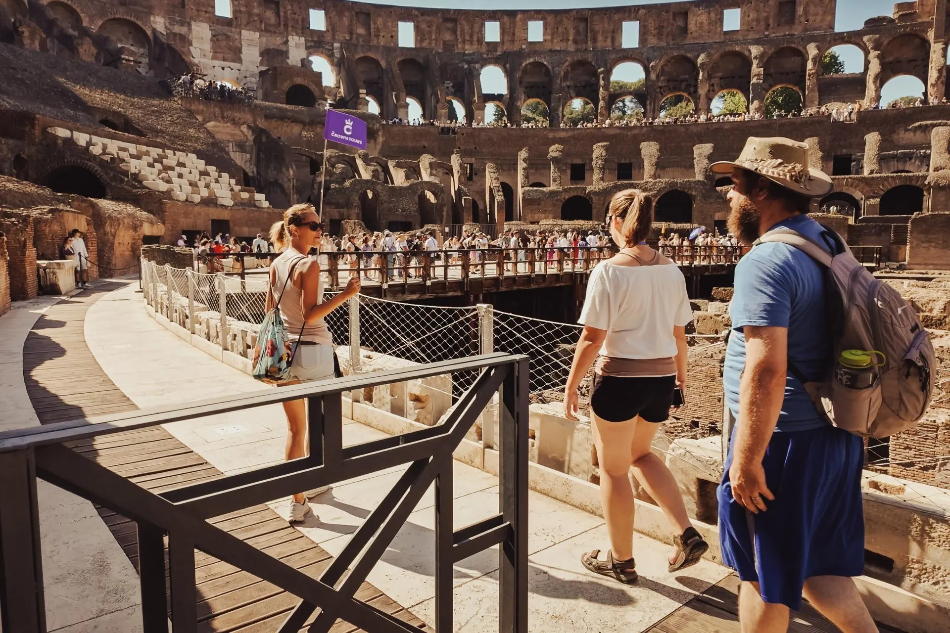 A guided group on the walkways inside the Colosseum