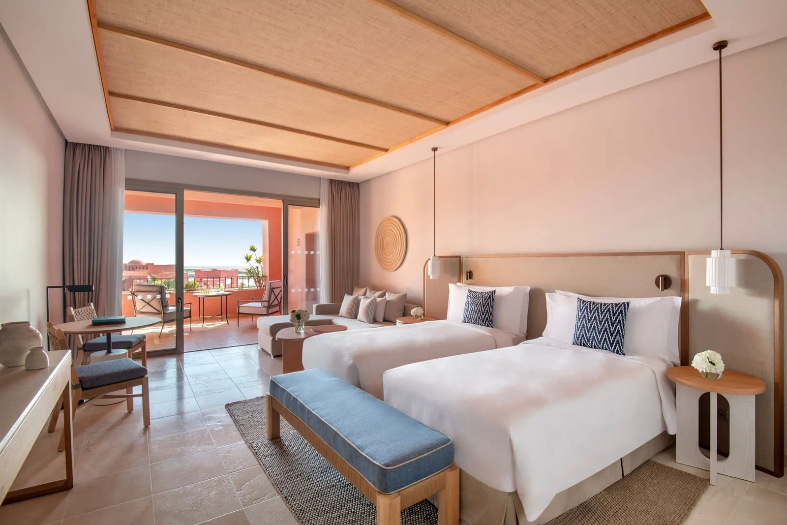 Family Room, Ocean View at the Ritz-Carlton Abama: two beds, a blue bench and a sitting area by the balcony doors