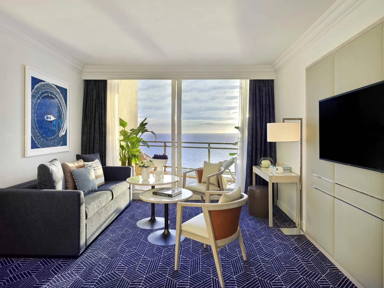 Riviera Suite Sea View at Fairmont Monte Carlo: the living room with a sofa and a terrace facing the sea