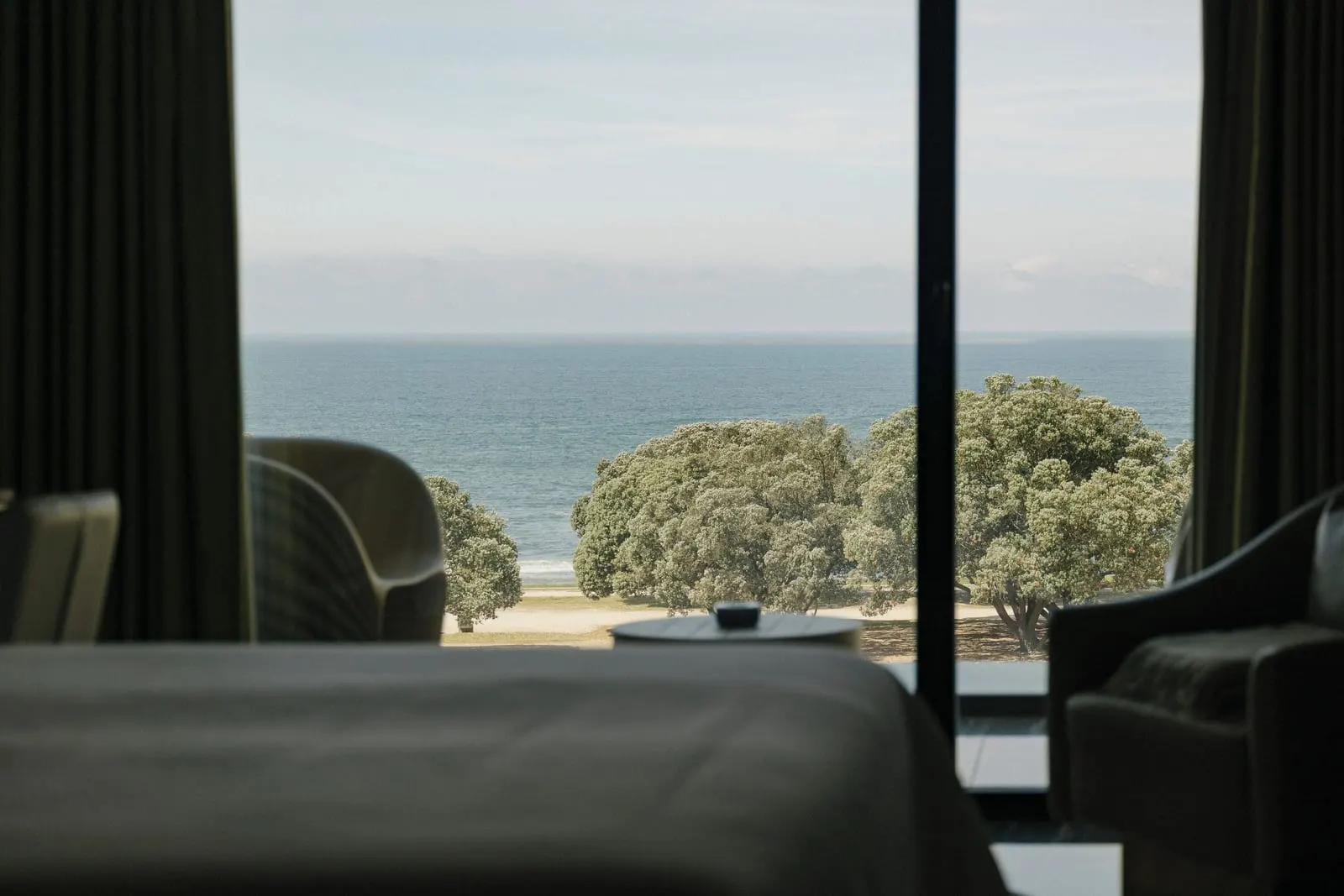 Onice Sea View Room at Vila Foz: the sea and trees beyond the balcony, seen past the foot of the bed