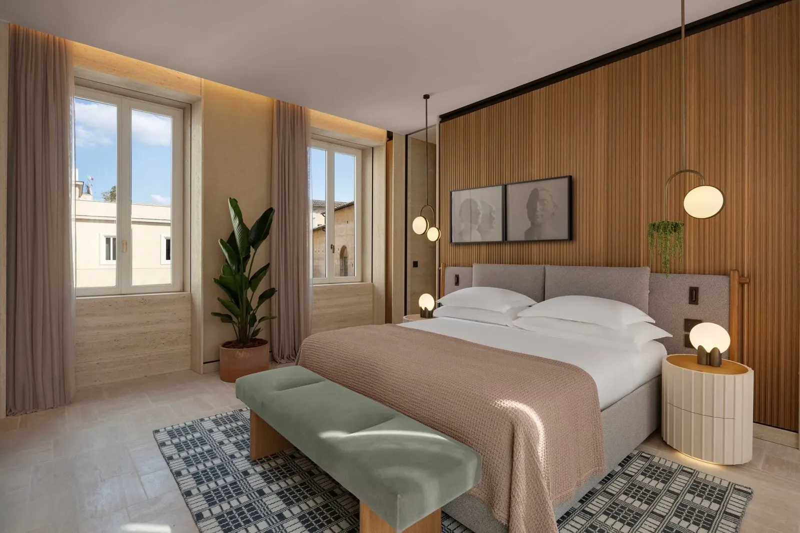 Mellini Suite at Six Senses Rome: a bedroom with a green bench, two tall windows and a plant