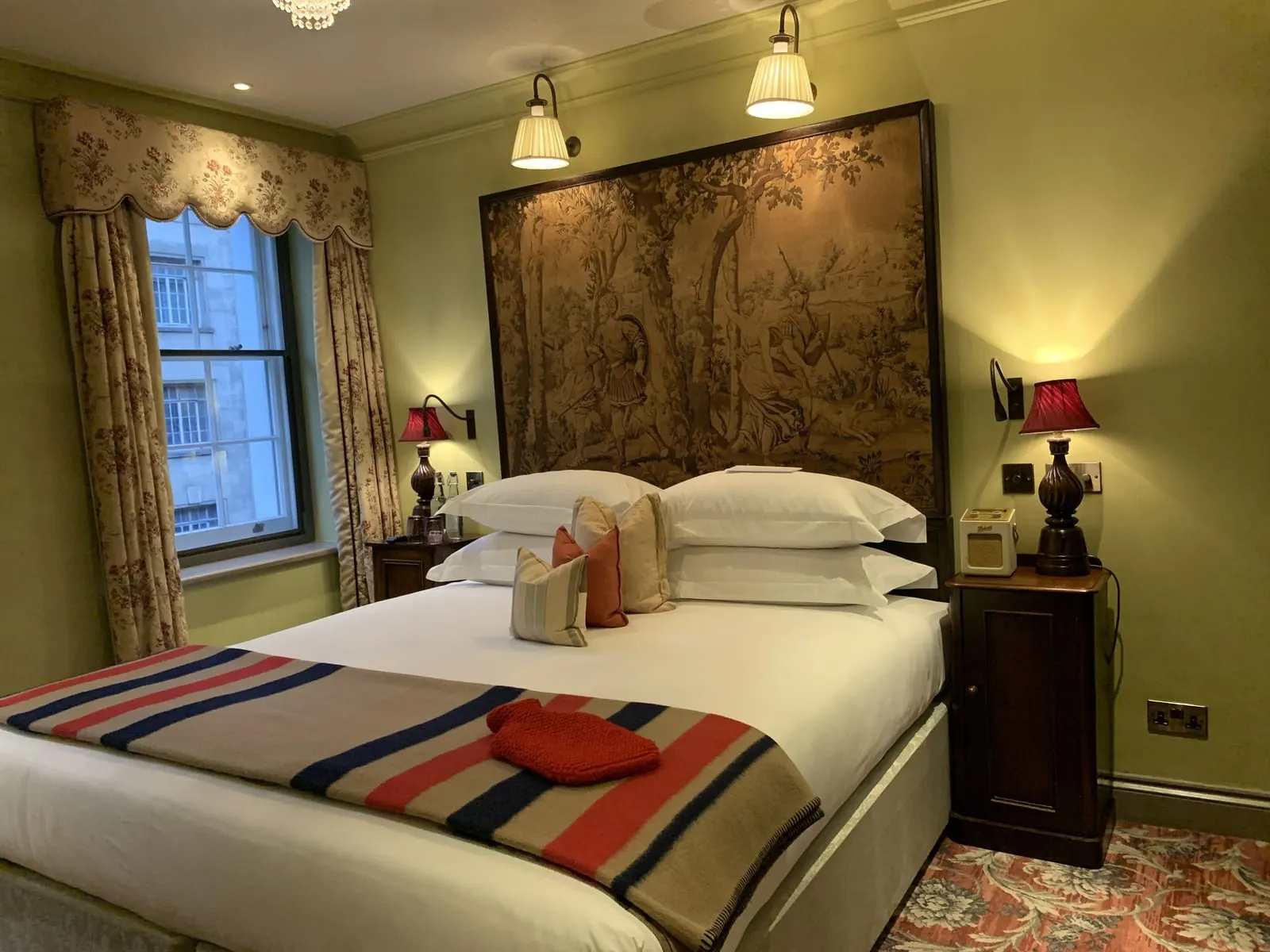Deluxe King at The Zetter Marylebone: the bed with a tapestry headboard, green walls and a curtained window