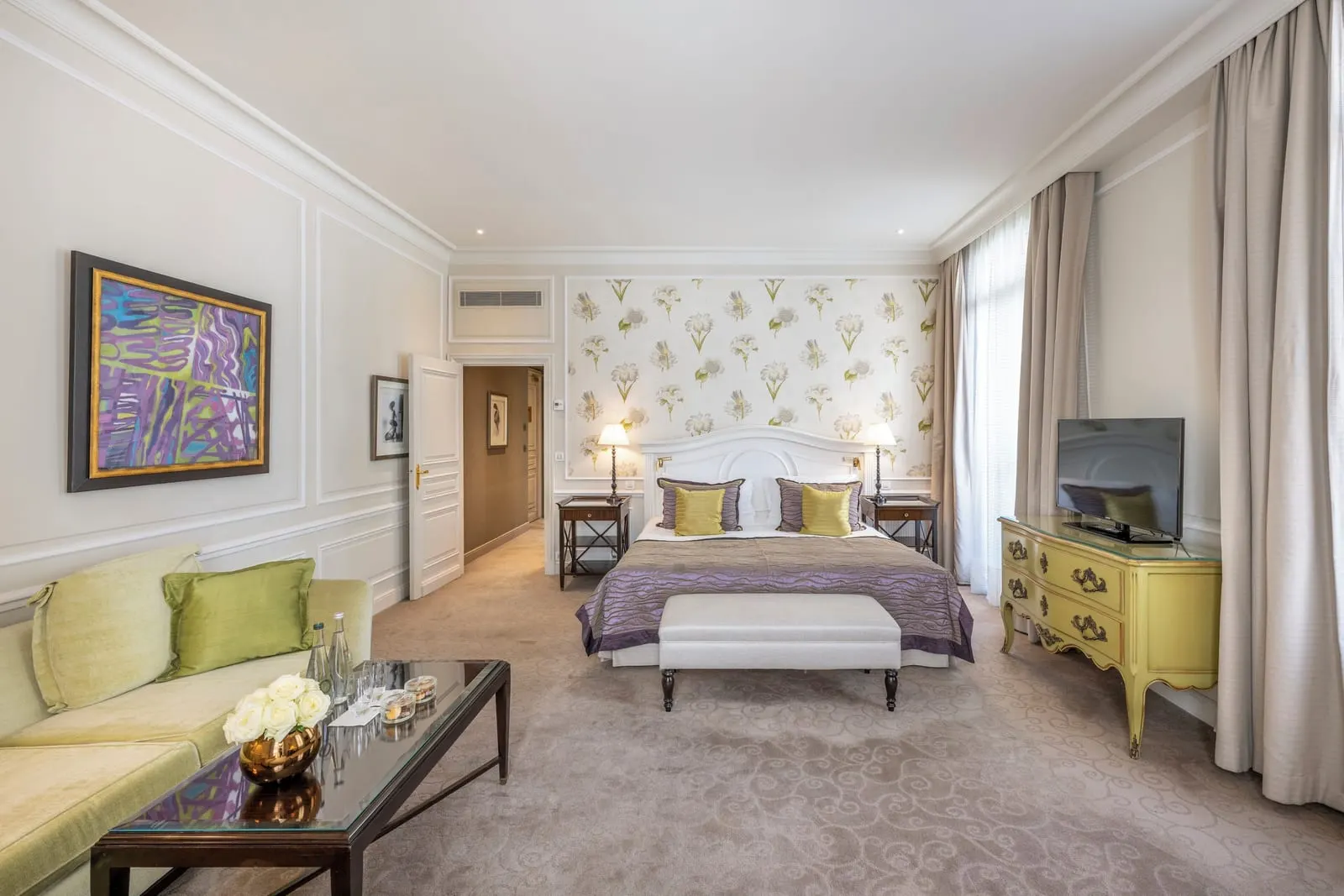 Junior Suite with city or courtyard view at Hôtel Hermitage Monte-Carlo: a sofa and coffee table in front of the bed