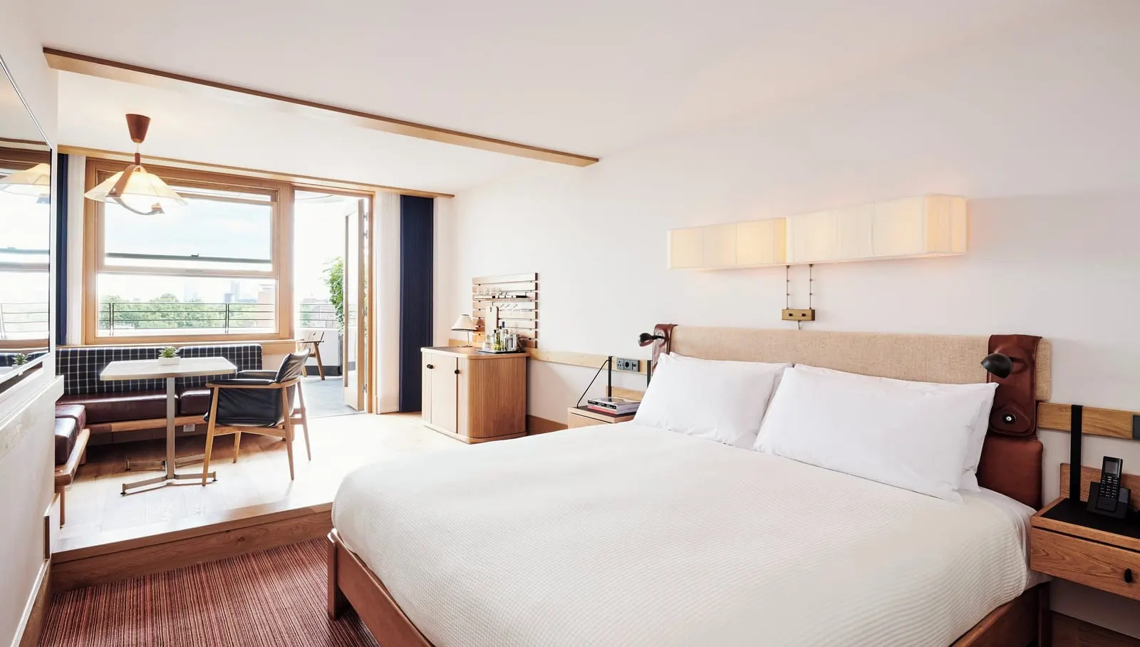 Studio Suite with Terrace at The Standard, London: the bed, a table with chairs and glass doors open to the terrace