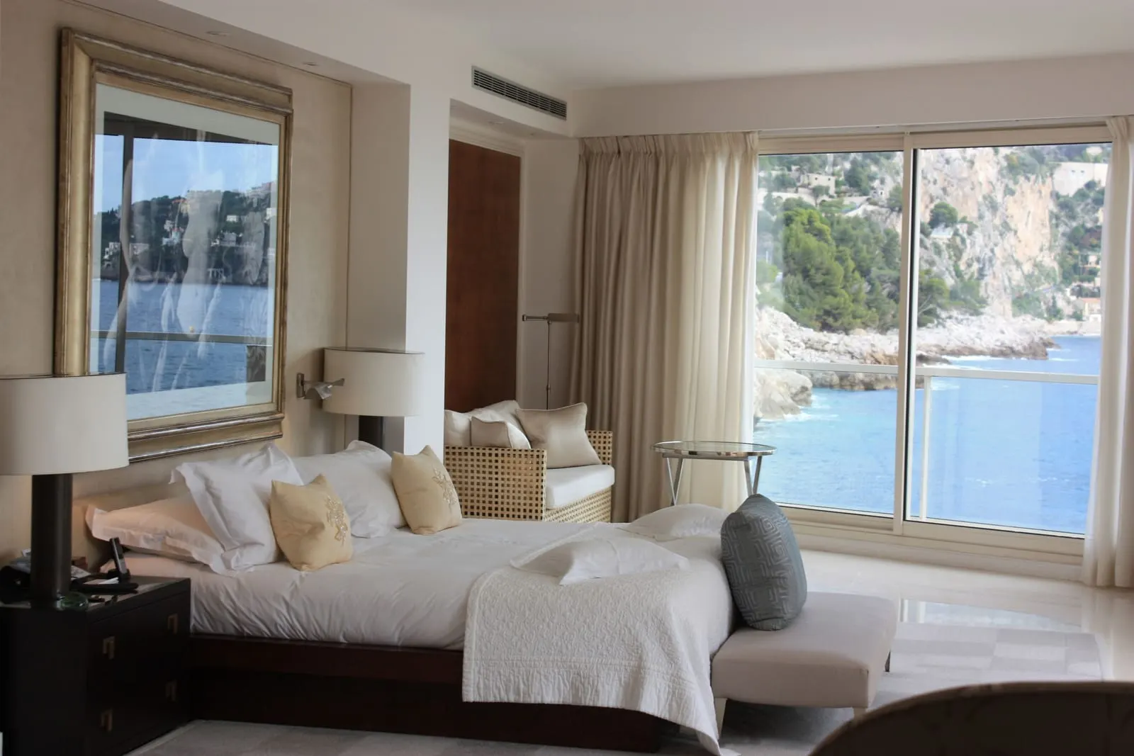 Dream Suite 112 at Cap Estel: the bedroom, its wide window onto the sea and the cliffs