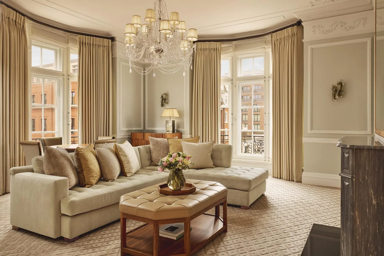Corner Suite at Claridge's: the living room with a corner sofa, a chandelier and bay windows