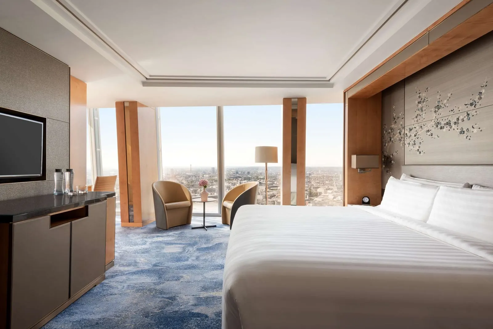 Premier City View Room at Shangri-La The Shard: the bed, an armchair and floor-to-ceiling windows over the city
