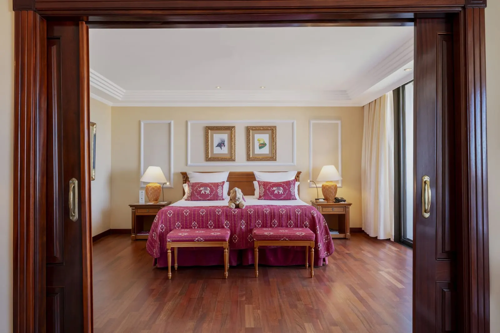Senator Suite Teide View at Hotel Botánico: the bedroom, twin beds with pink covers, through open wooden doors