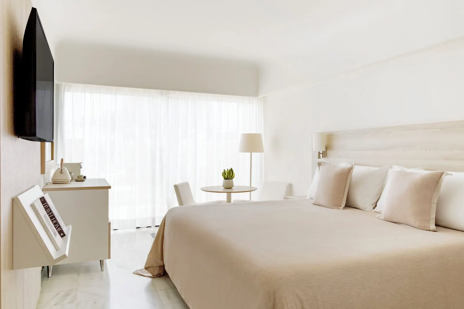 Premium Room at Paradisus Salinas Lanzarote: a king bed beside a window with a net curtain, a television and a small desk