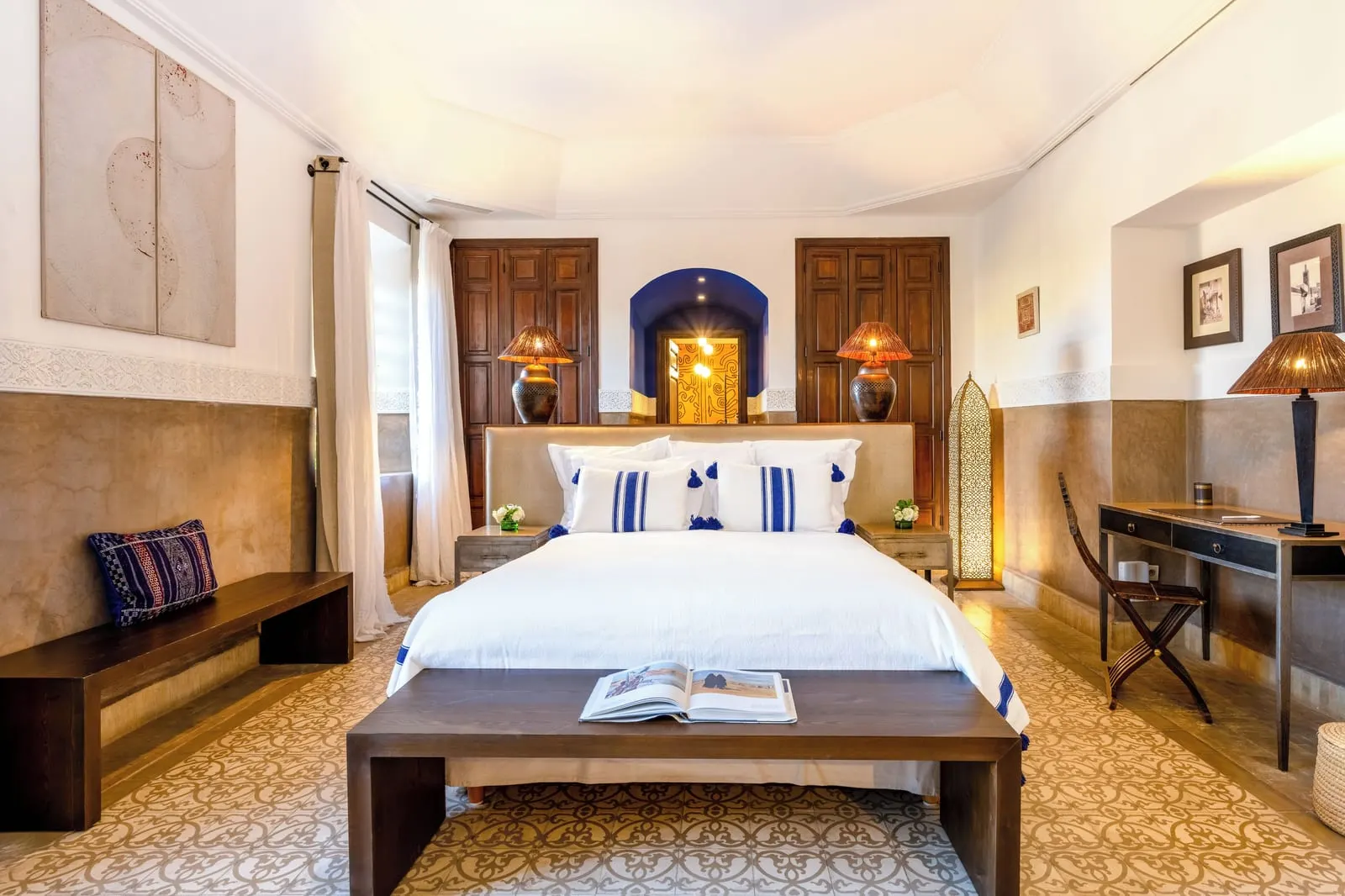 Large Suite with Terrace at La Villa des Orangers: a double bed with blue tasselled cushions, a bench at its foot and a desk to one side.