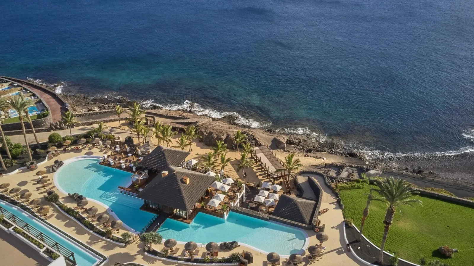 Secrets Lanzarote Resort & Spa: Pool terraces stepping down to the rocky shore