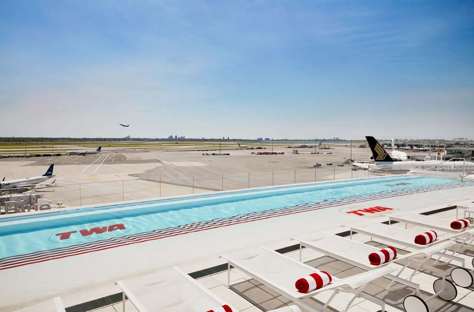 TWA Hotel: The rooftop pool, looking across the ramp to the runway