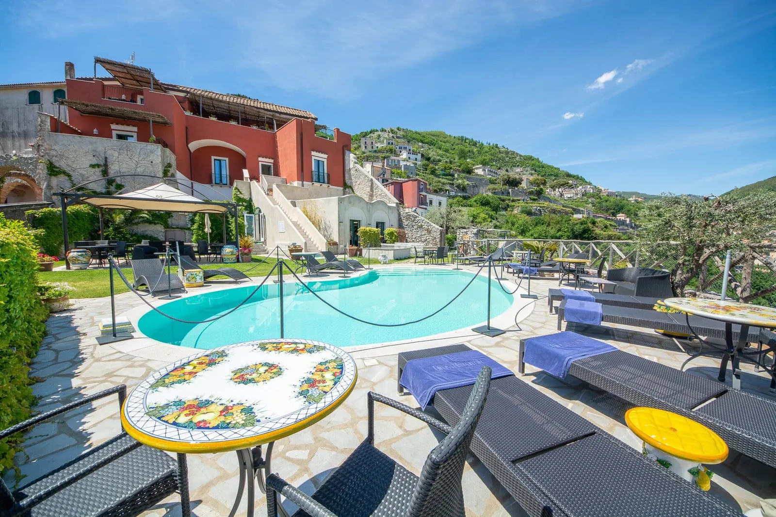 Palazzo Pascal: The pool below the palazzo, with majolica tables