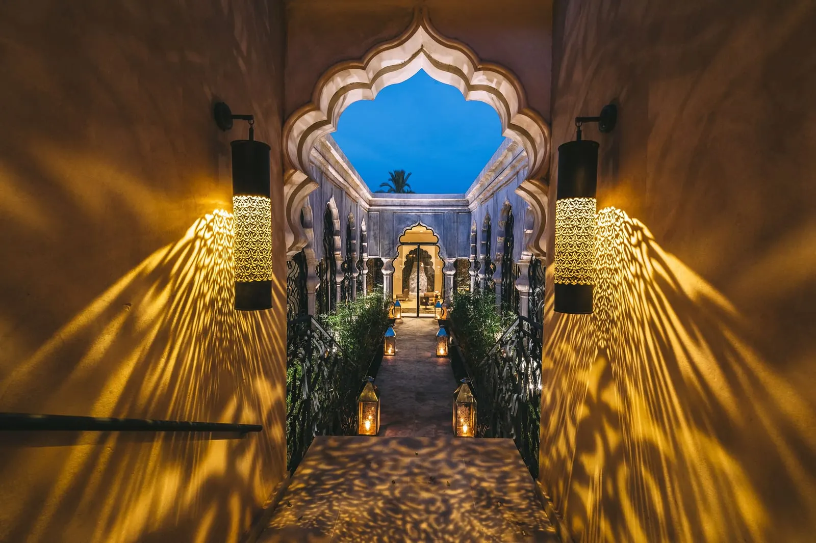 Palais Namaskar: A lantern-lit passage through carved arches