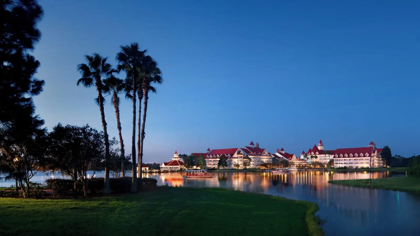 Disney's Grand Floridian Resort & Spa: The resort lit up at dusk on the lagoon