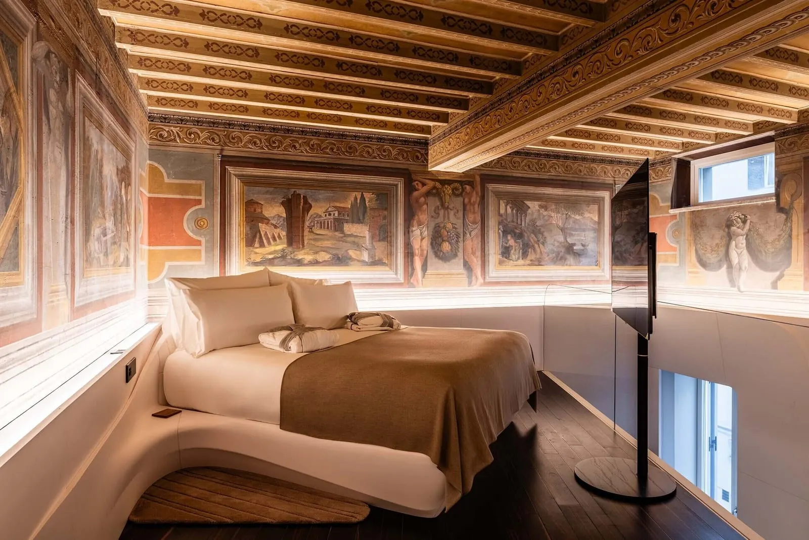 ROMEO Roma: A bed under a painted 17th-century ceiling