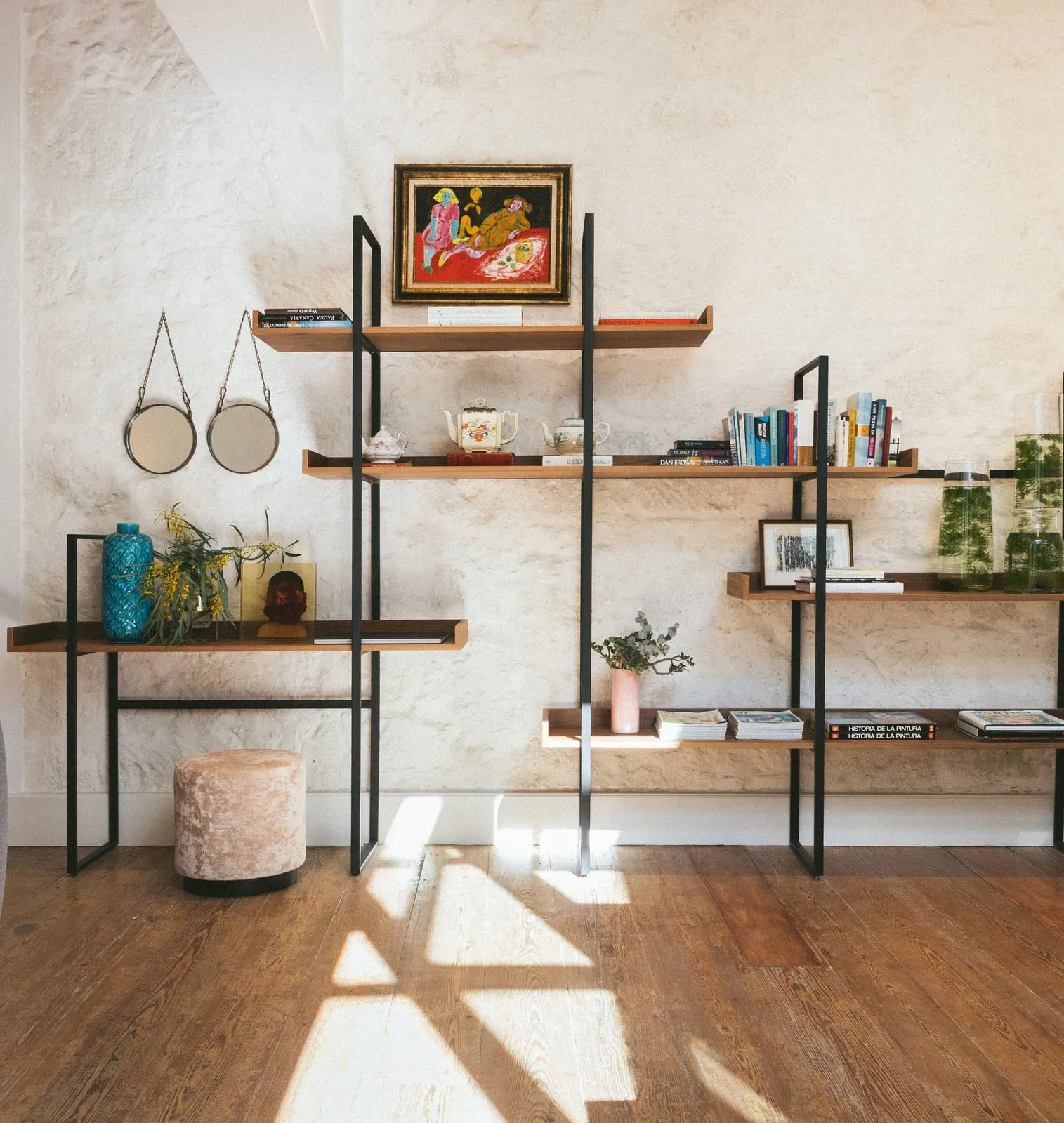 Hotel Veintiuno: Books and art against an old stone wall