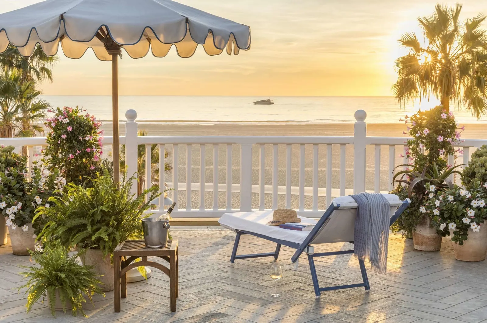 Shutters on the Beach: A terrace facing the beach at sunset