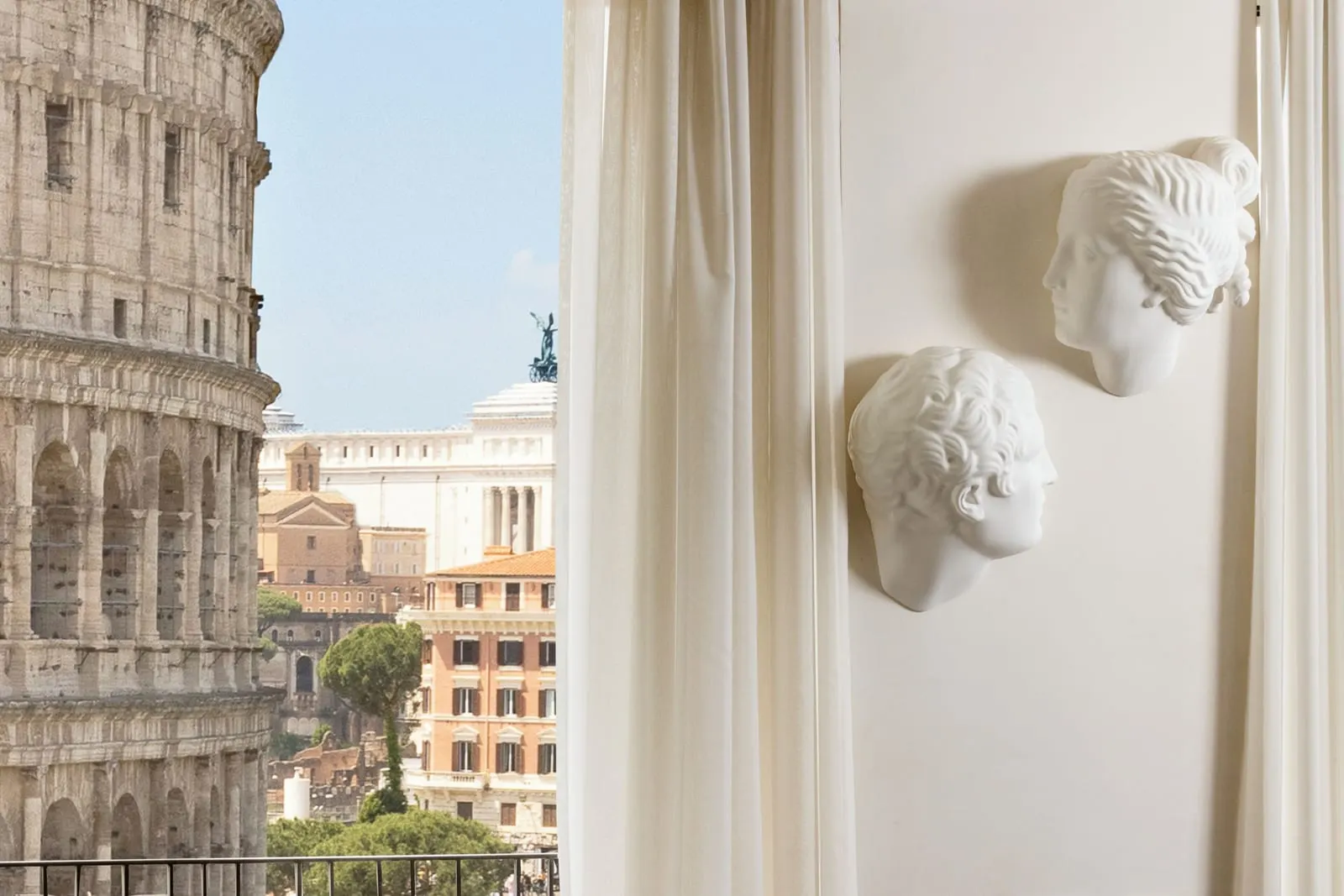 Palazzo Manfredi: Roman heads, and the Colosseum through the curtains