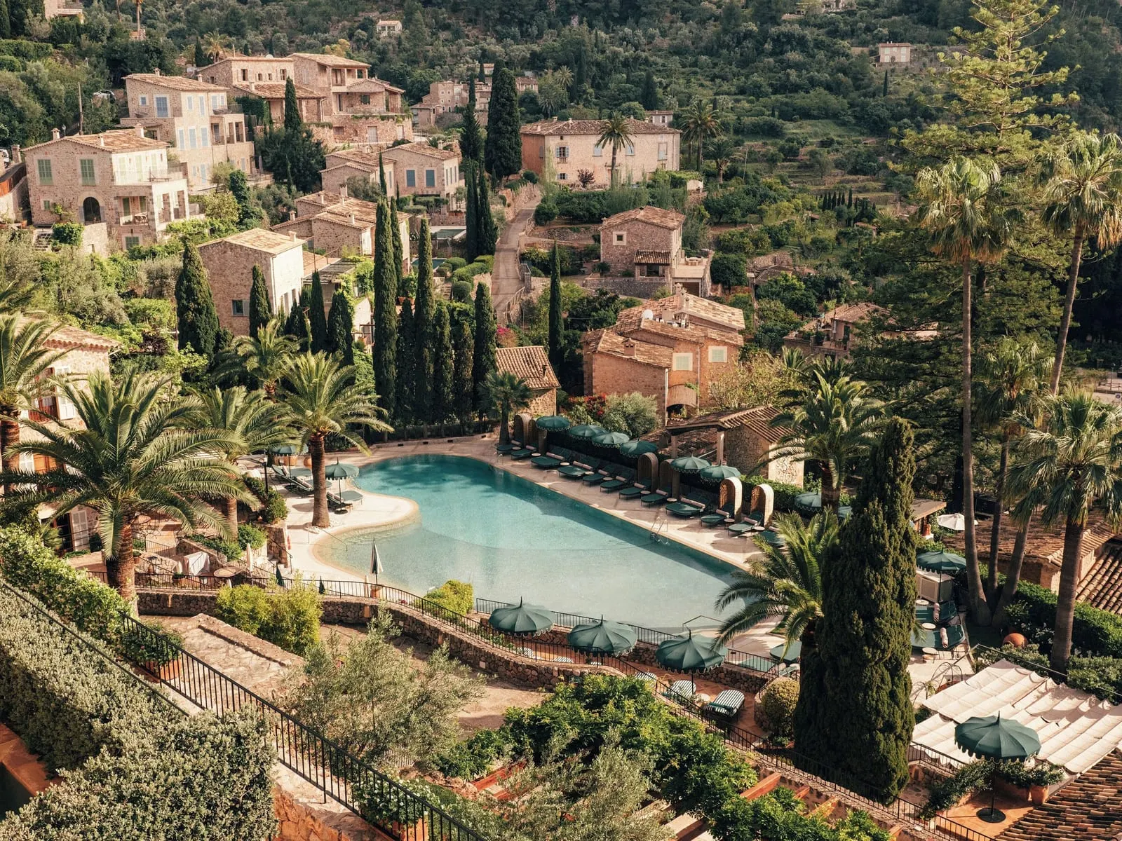 La Residencia, A Belmond Hotel: The pool among palms, cypresses and stone houses