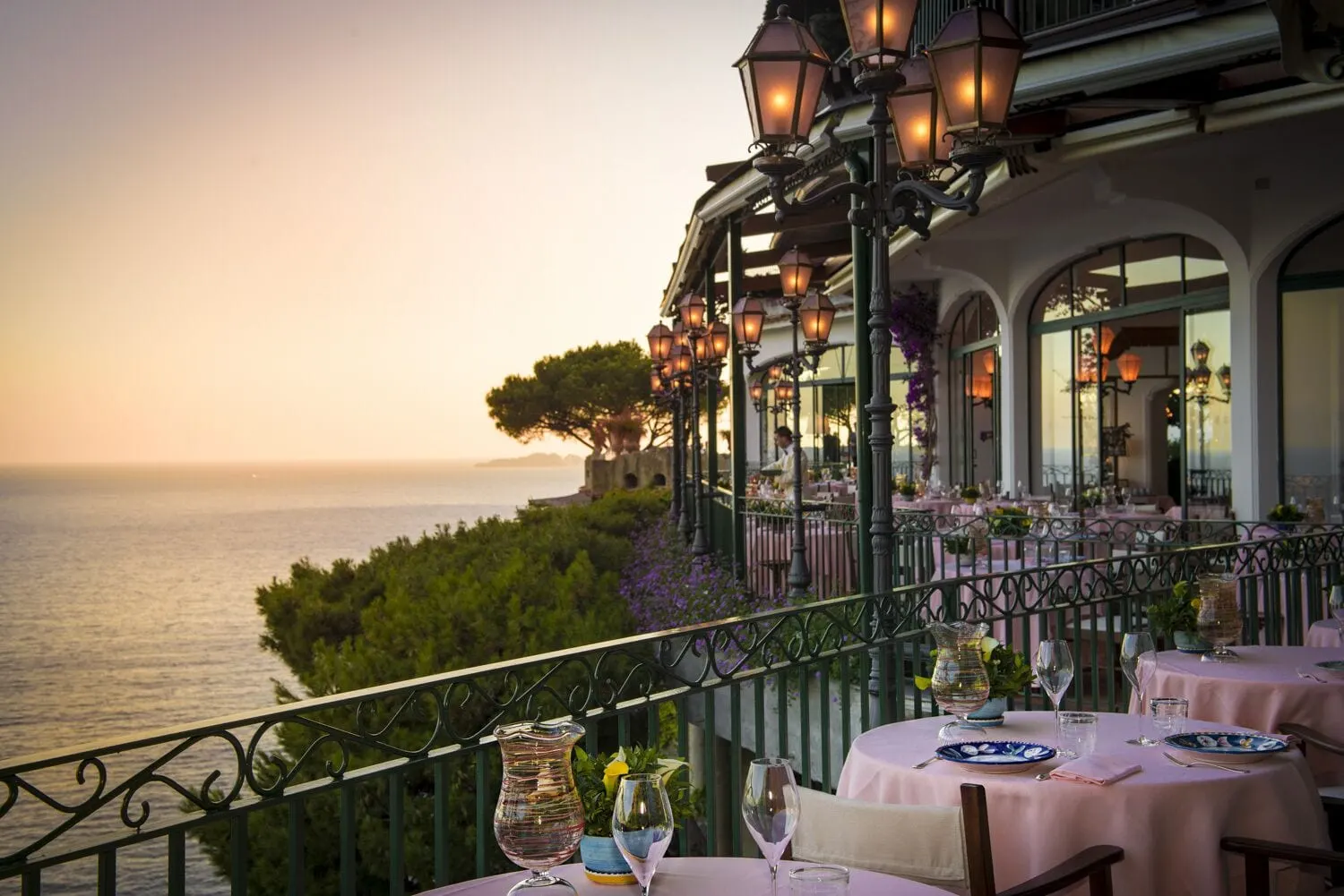 Il San Pietro di Positano: Dinner tables on the lantern-lit terrace at dusk