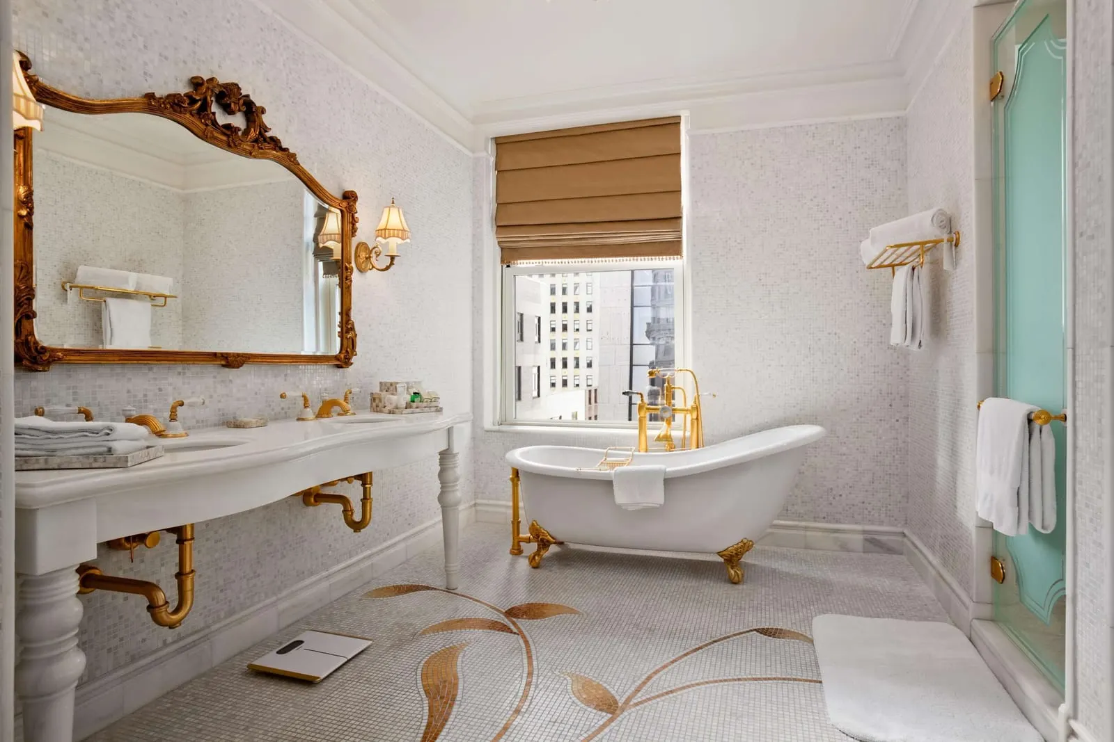 The Plaza: A marble bathroom with gold fittings and a freestanding tub