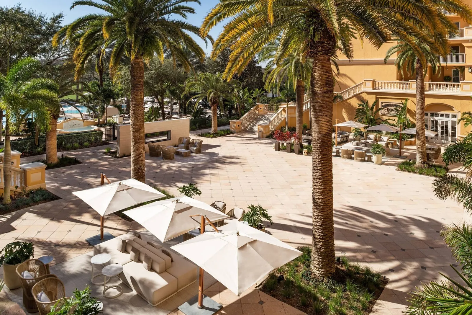 The Ritz-Carlton Orlando, Grande Lakes: A palm-shaded terrace by the pool