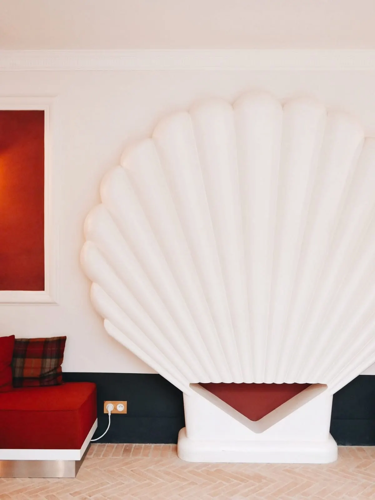 Grands Boulevards Experimental: A sculpted shell beside a red banquette