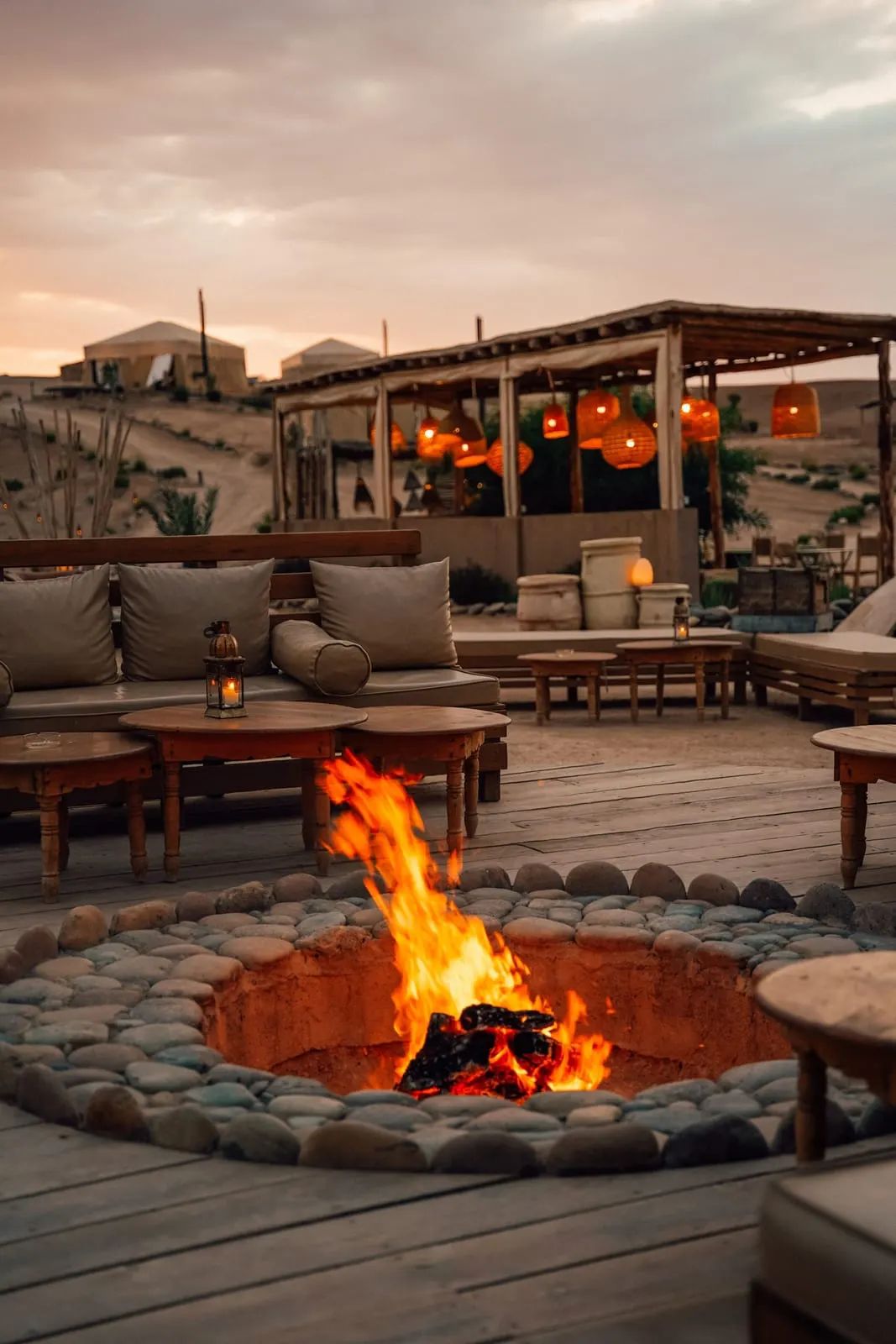 Inara Camp: The fire pit lit at dusk