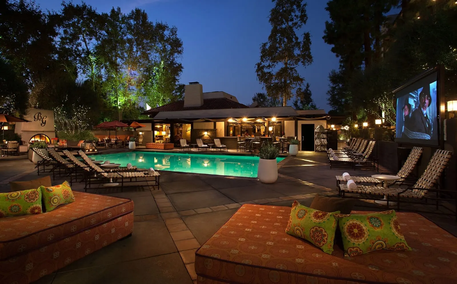 The Garland: The pool and its outdoor movie screen at dusk