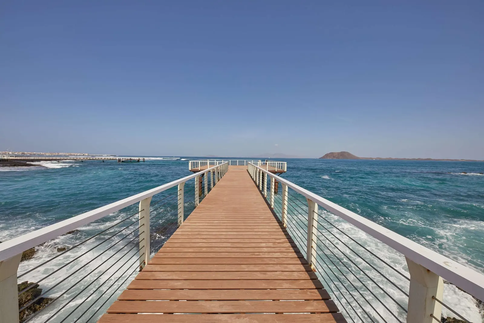 Secrets Bahía Real Resort & Spa: The pier reaching out over the rocks