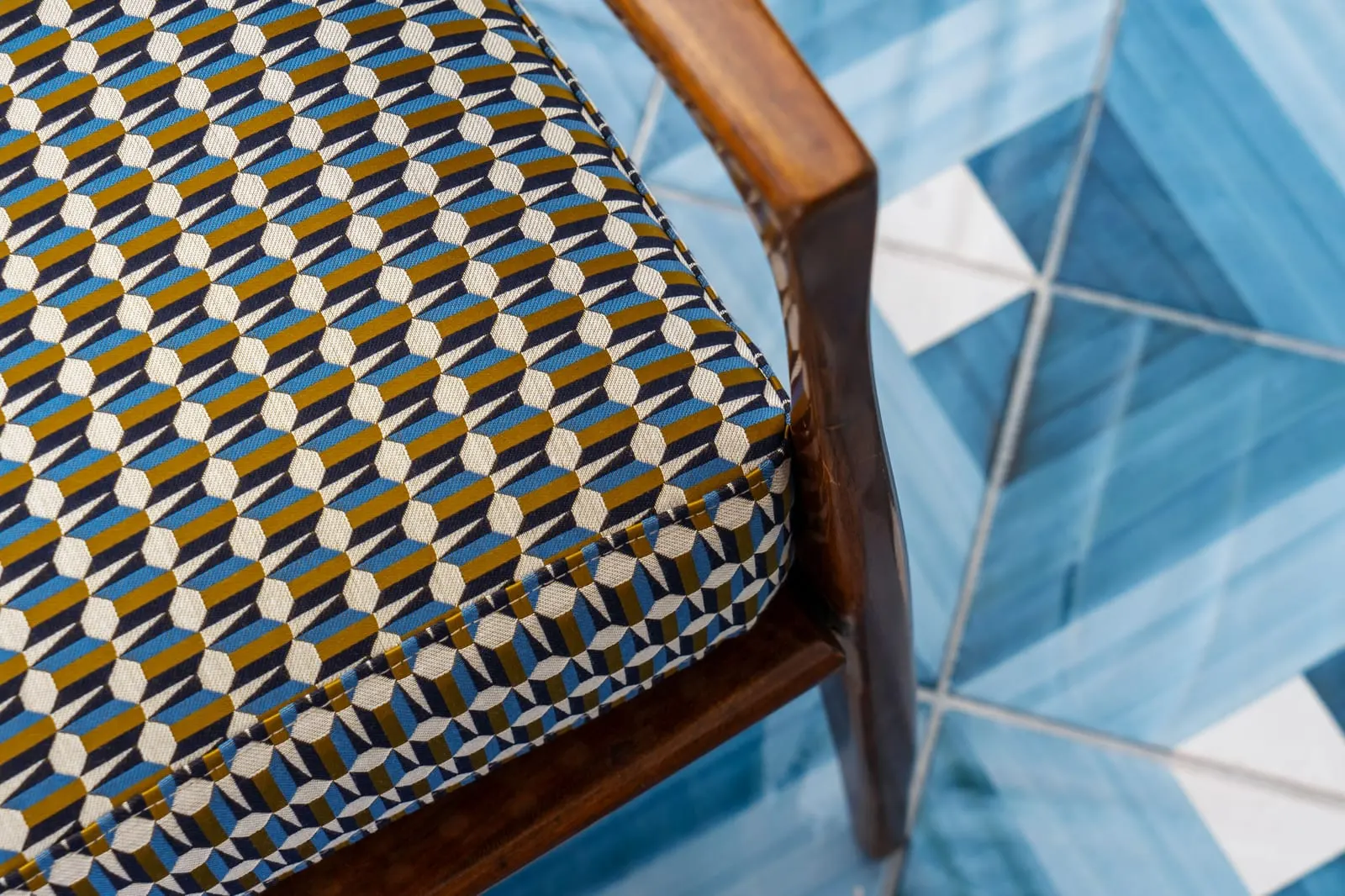 Borgo Santandrea: Patterned upholstery over hand-painted blue tile