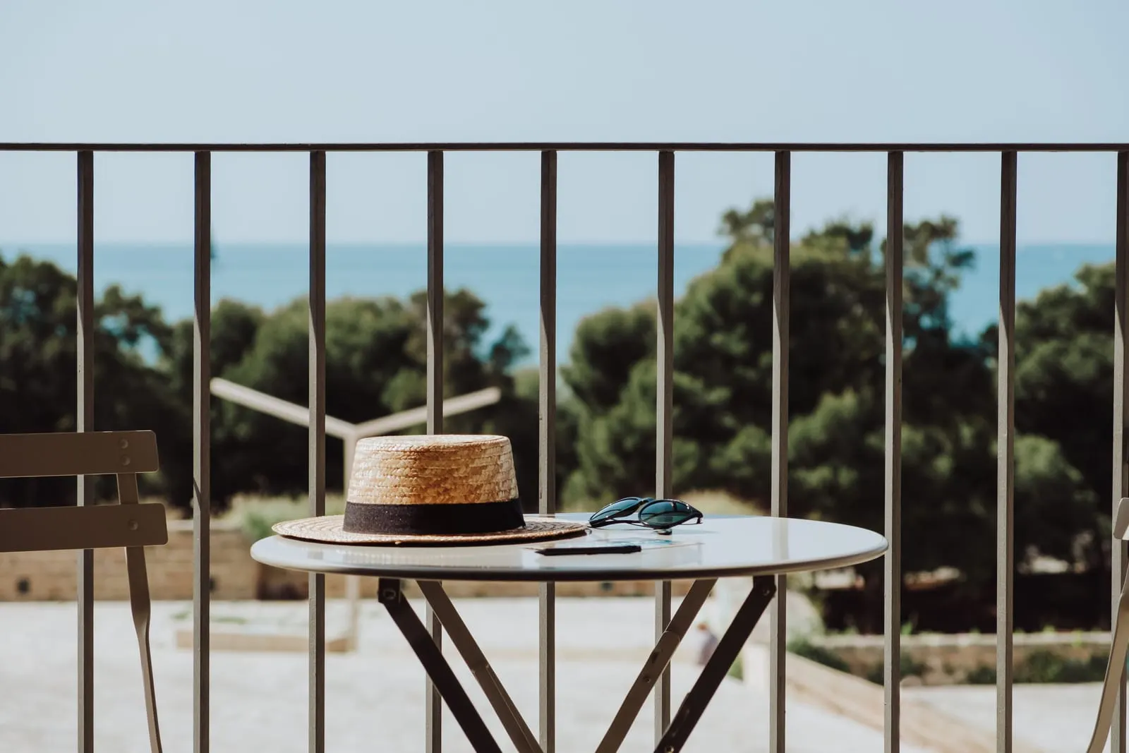 Es Princep: A balcony table, with the pines and sea beyond