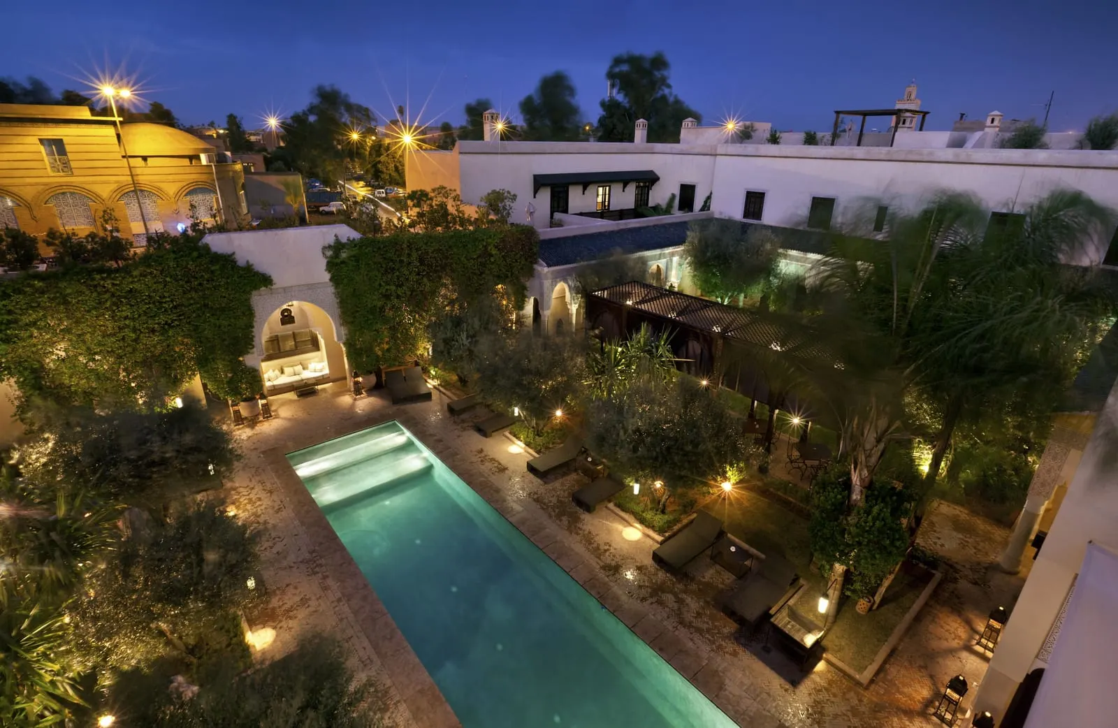 La Villa des Orangers: The pool patio and rooftops at dusk