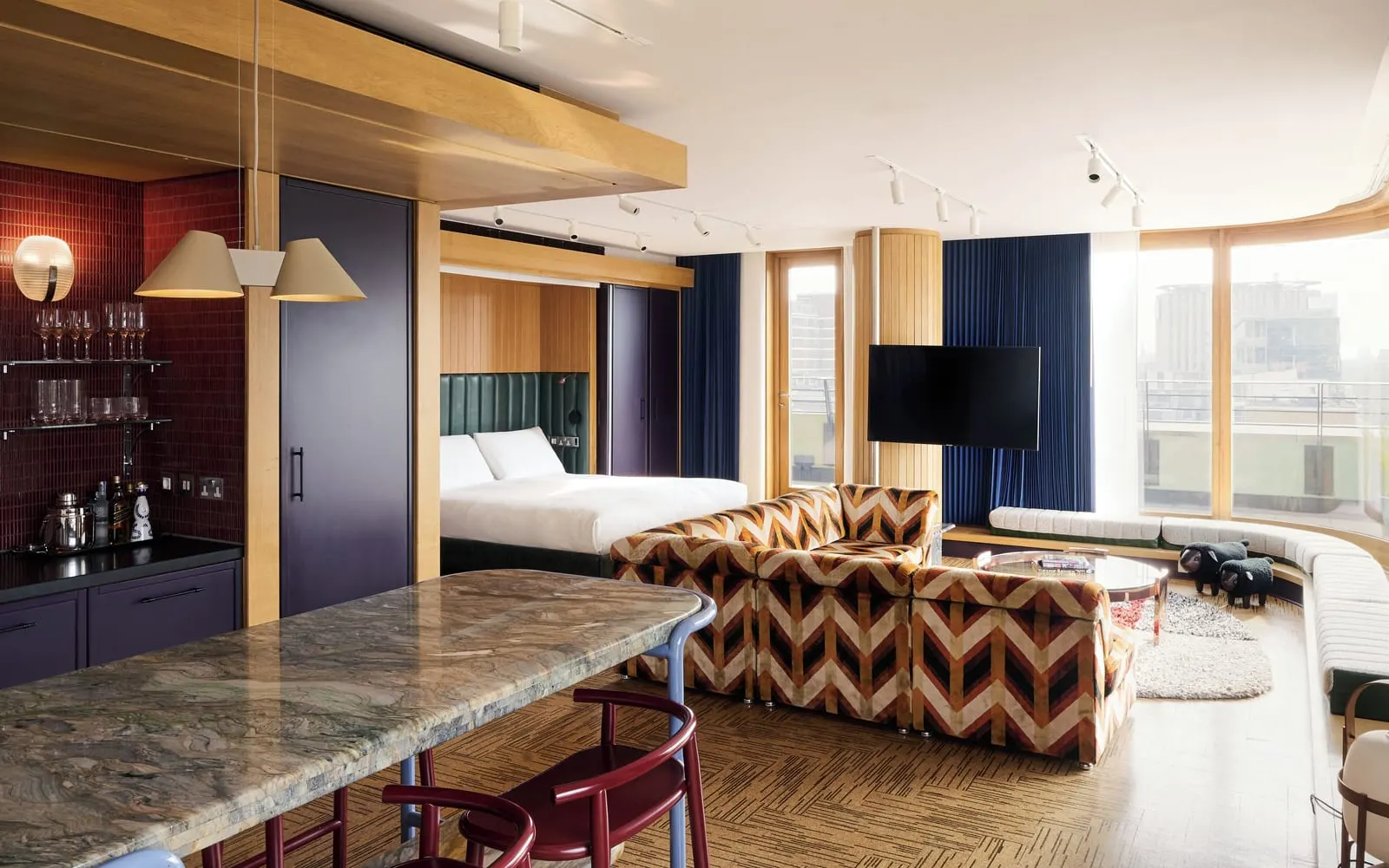 Deluxe Studio Suite with Wraparound Terrace at The Standard, London: chevron armchairs, a marble counter and the bed beyond