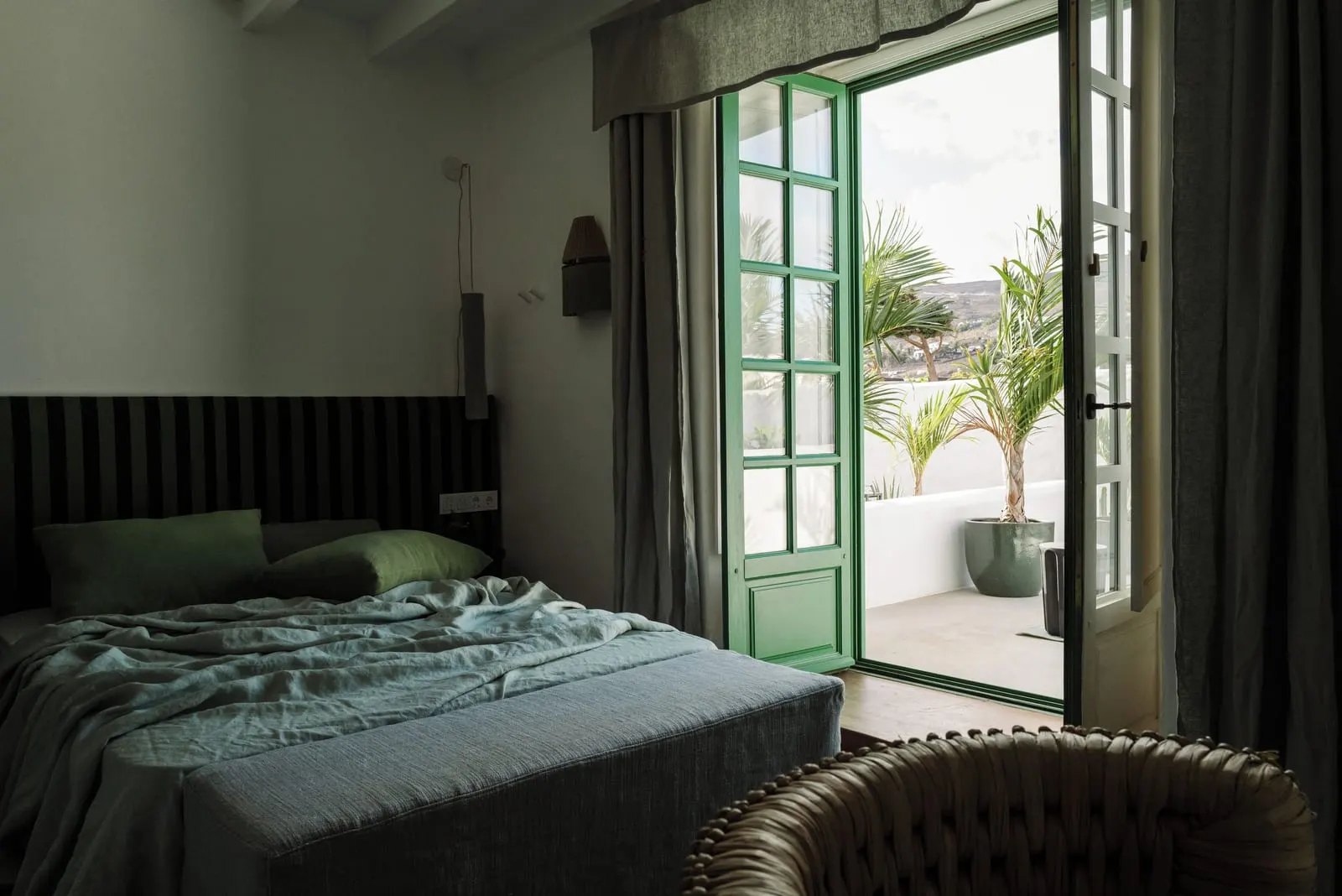 Double Room at Hotel César Lanzarote: a double bed in a dark-striped bedroom with green-framed doors open to a terrace