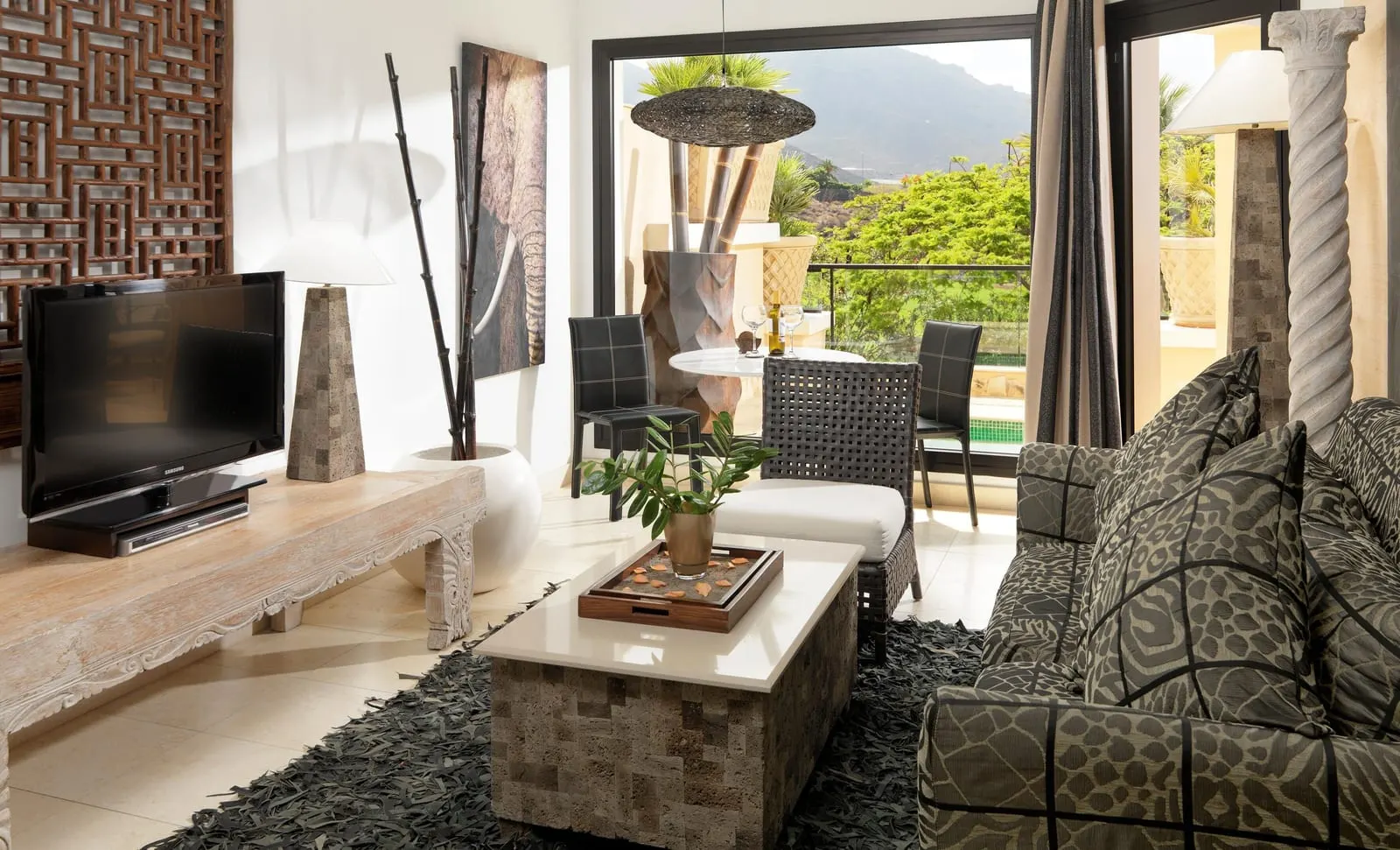 Duchess Villa at Royal Garden Villas: the living room, with a sofa, a television and doors open to the terrace