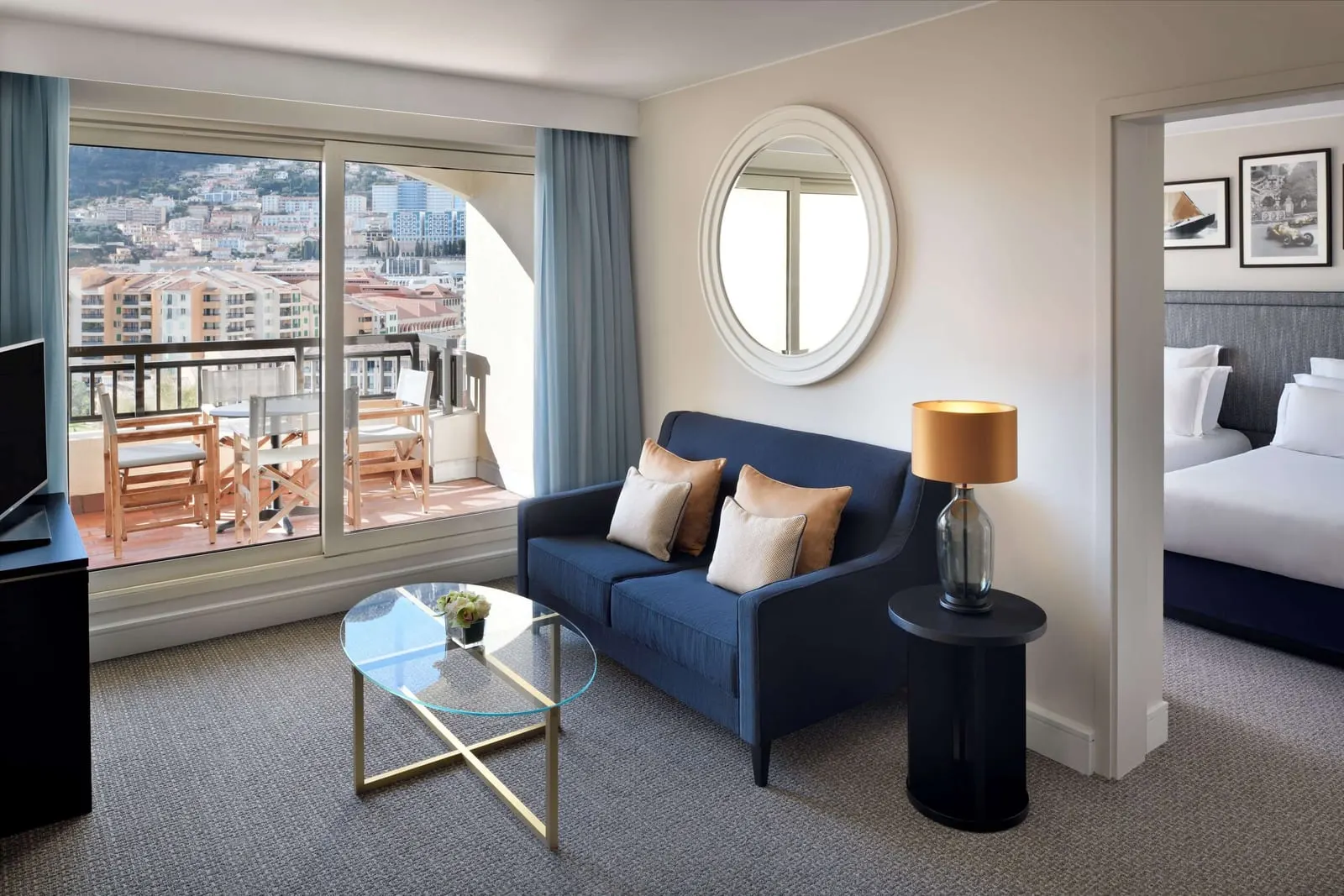 Columbus Suite at Columbus Hotel Monte-Carlo: the living room with a blue sofa and a terrace over the town