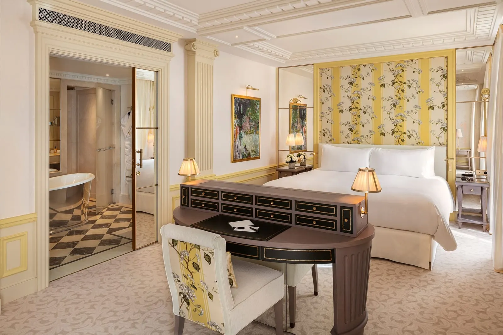 Deluxe Premium Junior Suite at Hôtel Métropole Monte-Carlo: the bed behind a desk, a freestanding bath through the doorway