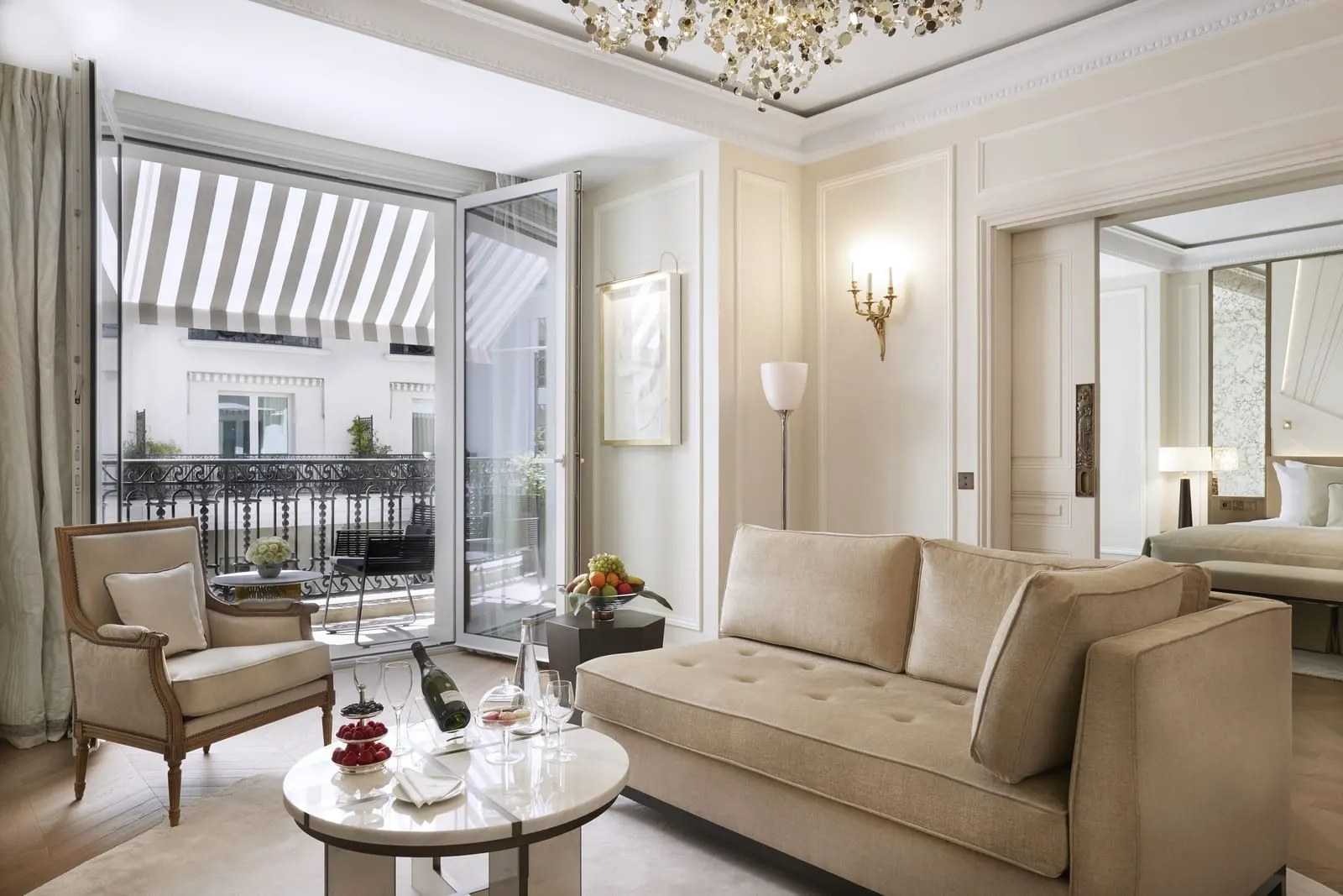 Suite with city or patio view at Hôtel de Paris Monte-Carlo: the sitting room, doors open to the balcony and the bedroom beyond
