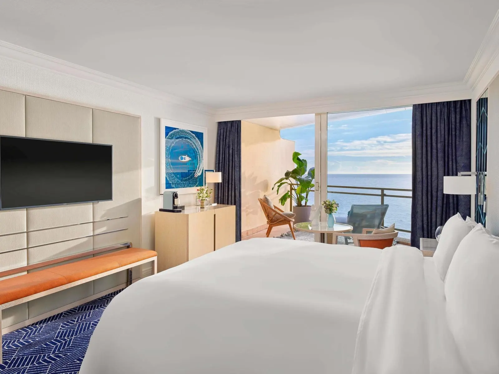Deluxe Sea View room at Fairmont Monte Carlo: the bed facing a window onto the terrace and the sea
