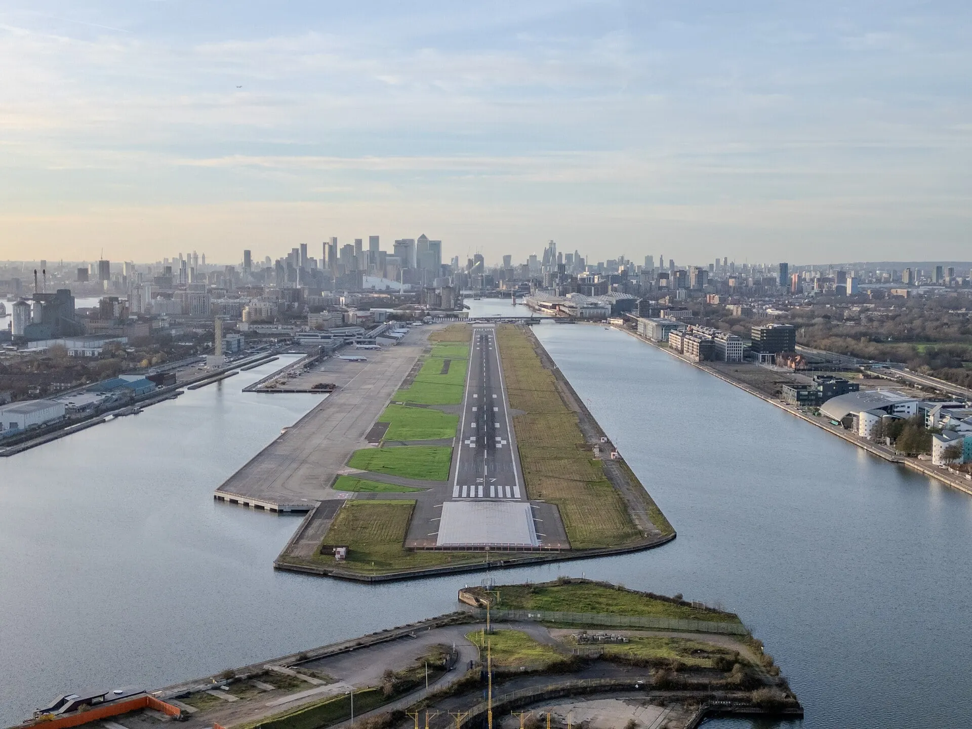 London City Airport's runway between the Docklands basins, with Canary Wharf beyond