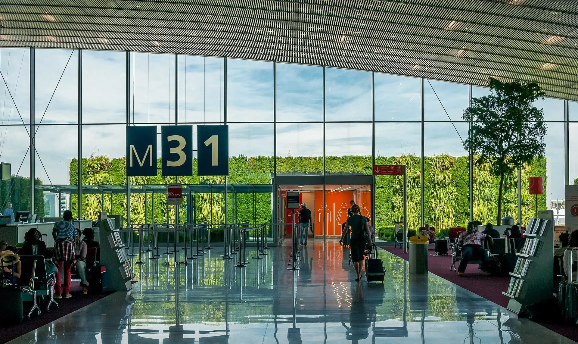 Gate M31 in Terminal 2E at Paris Charles de Gaulle, with a living green wall behind the glass