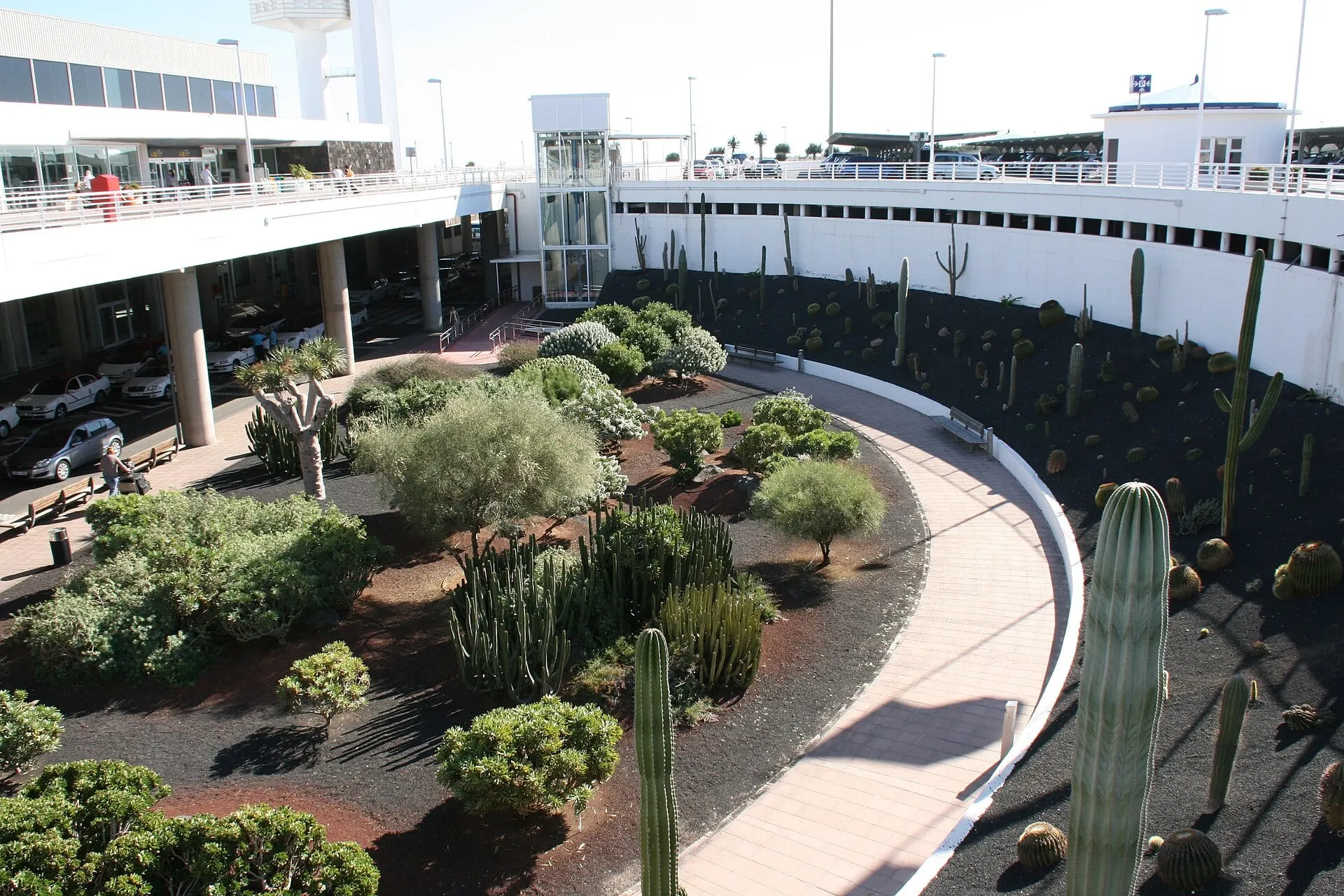 The terminal building at Lanzarote Airport, with a volcanic garden of cacti beside the access ramp