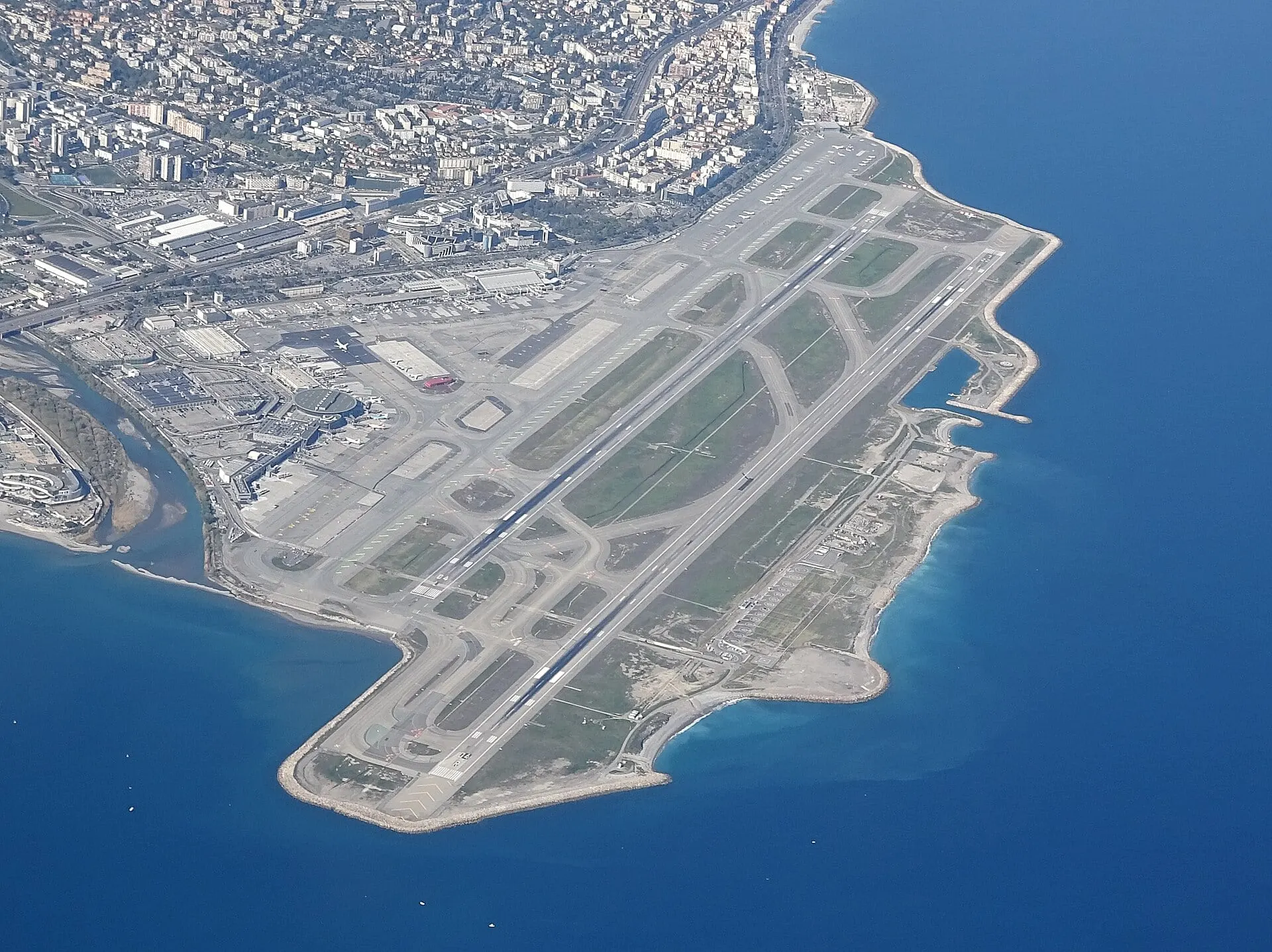 Nice Côte d'Azur Airport from the air, its runways built out into the Mediterranean