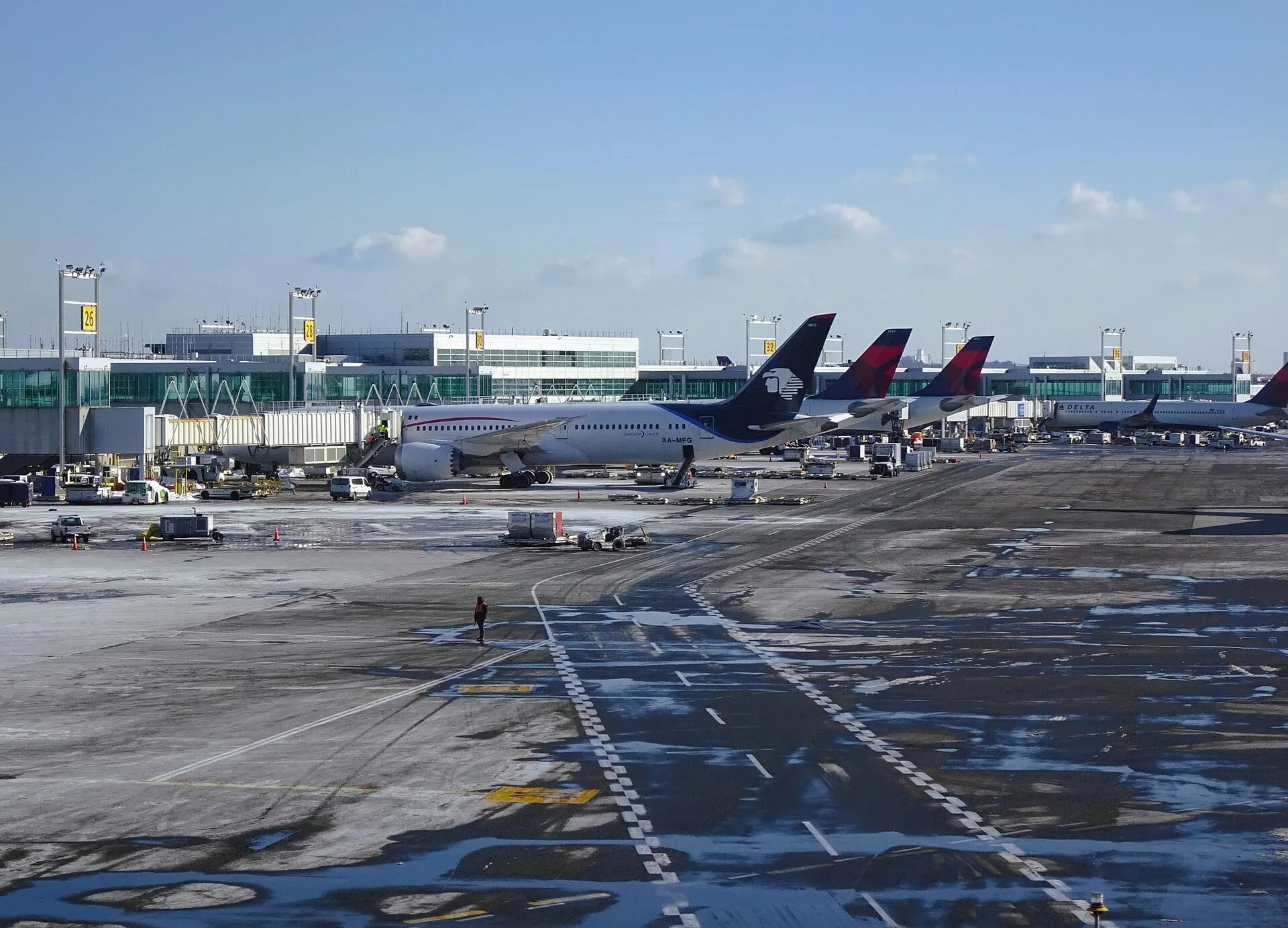 Aircraft lined up at the Terminal 4 gates at JFK on a clear winter day