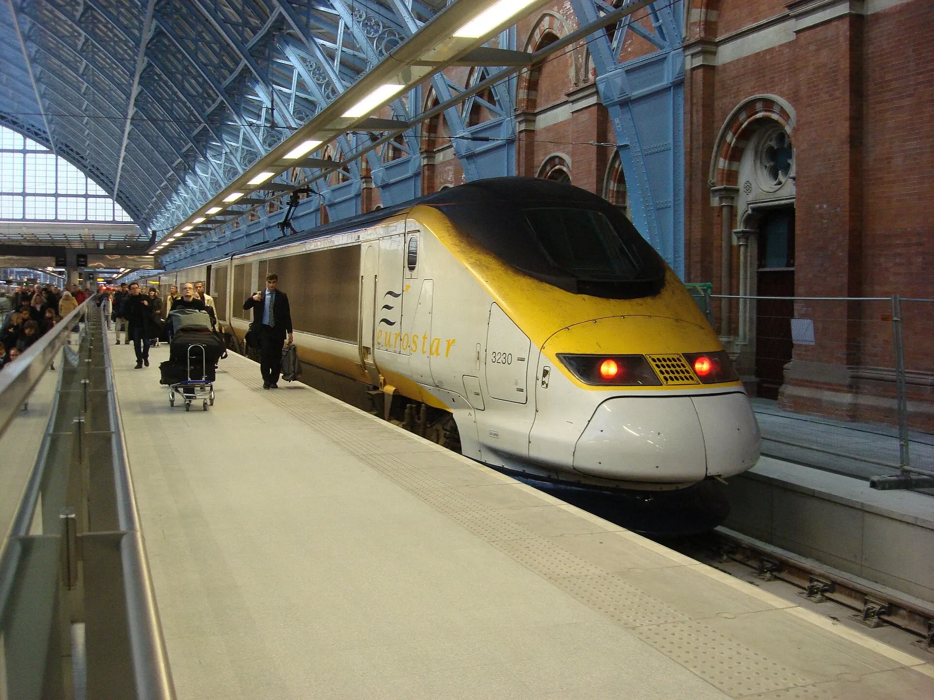 A Eurostar train at its platform under the iron and glass roof of St Pancras International