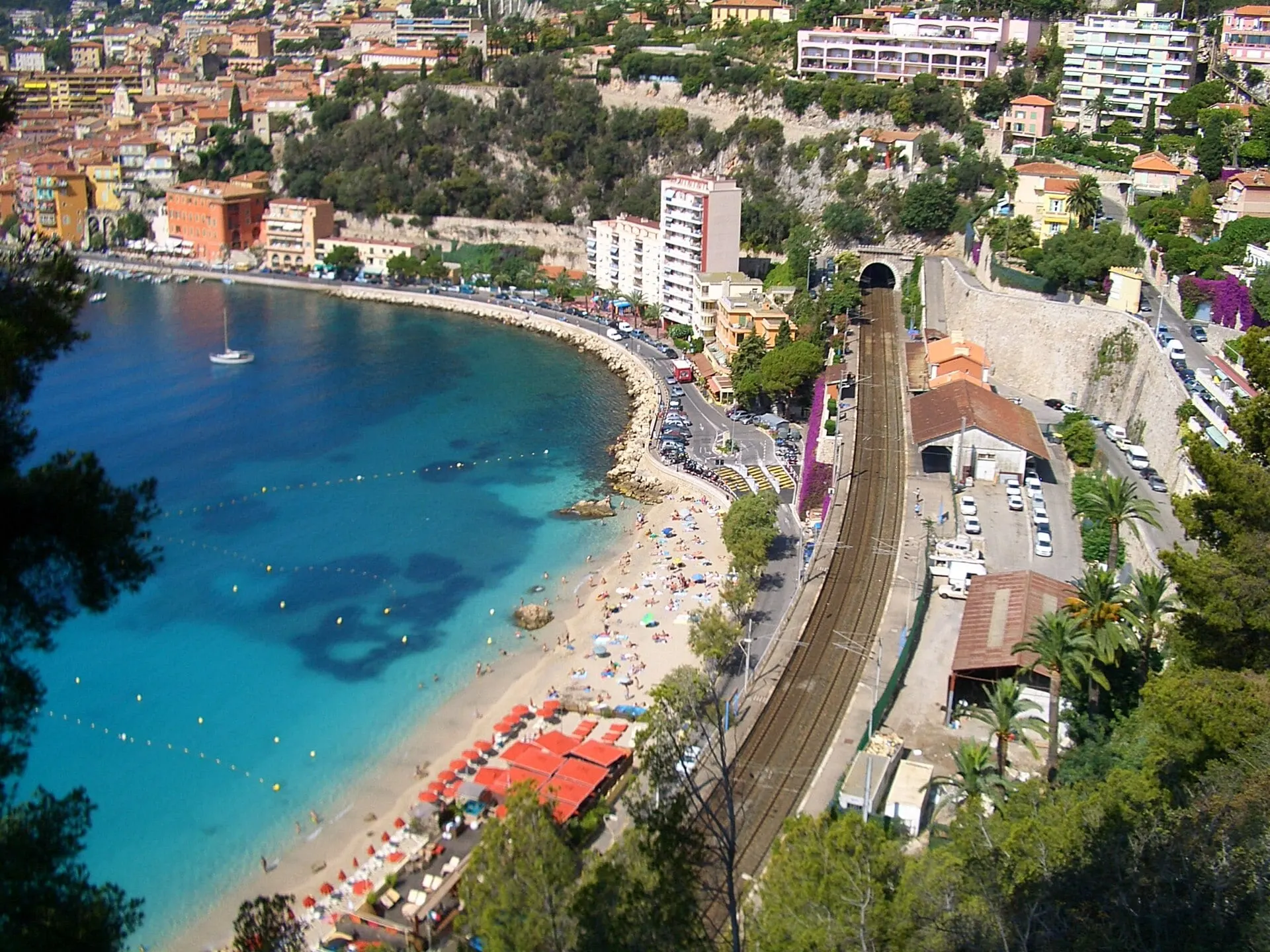 The bay of Villefranche with its curving beach and the railway running past the town to a tunnel.